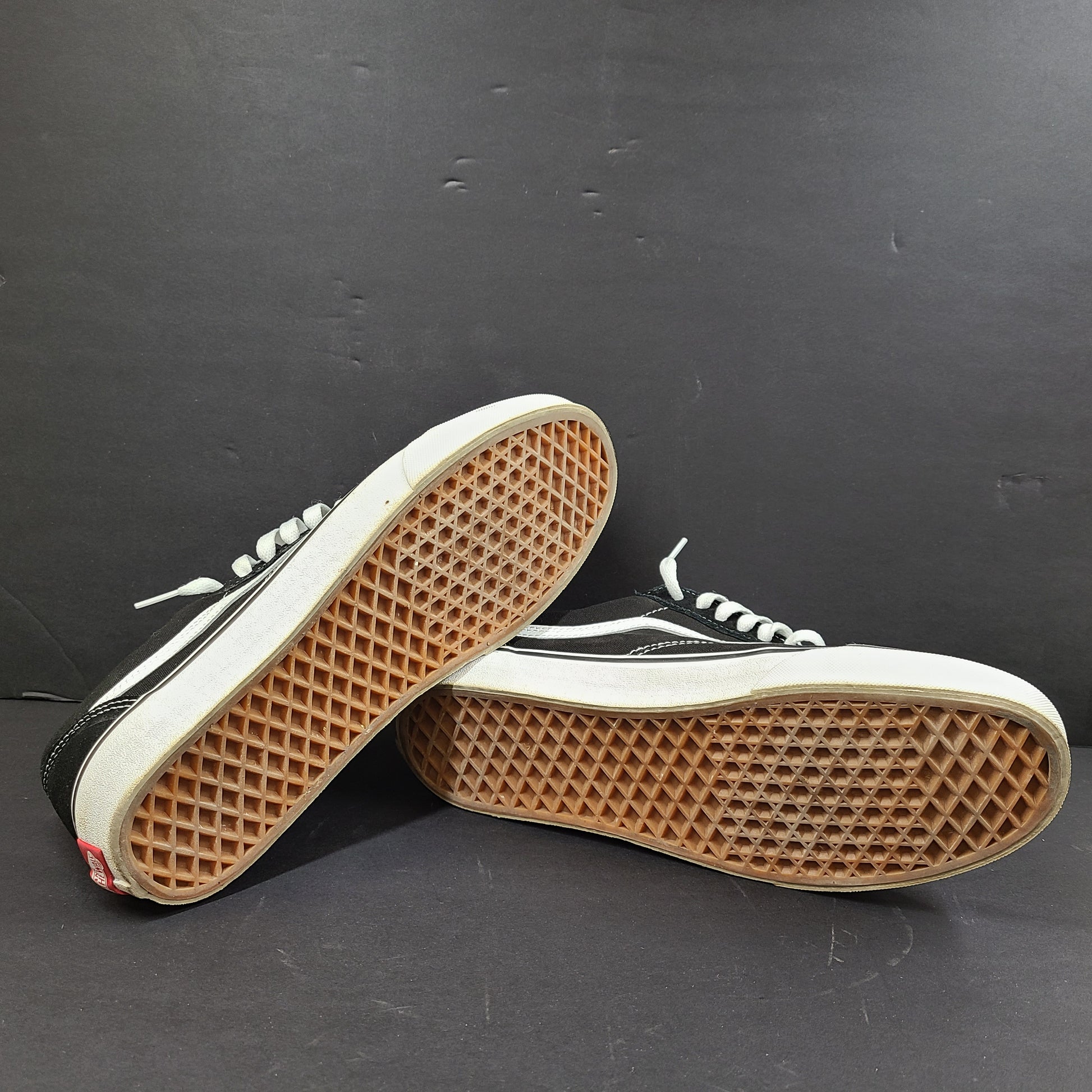 Low-top Vans Old Skool skate shoe in black with a white side stripe and vulcanized sole.