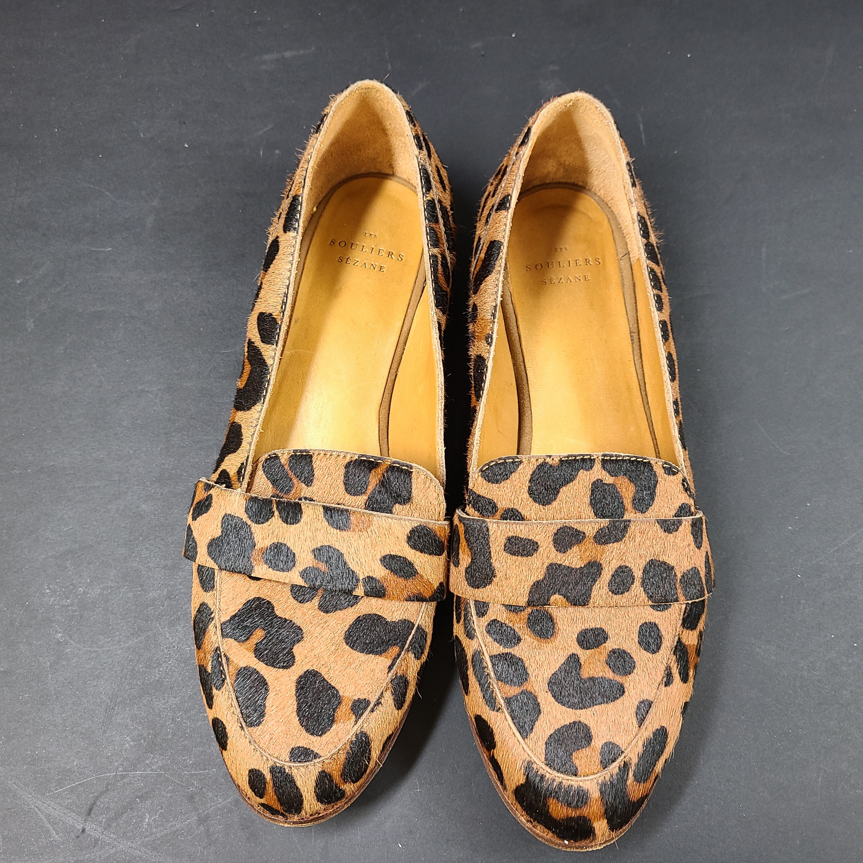 Leopard-print Sézane loafers feature a low profile, branded insole reading "SOULIERS SÉZANE" and a sole stamped "made in Portugal" and 39.