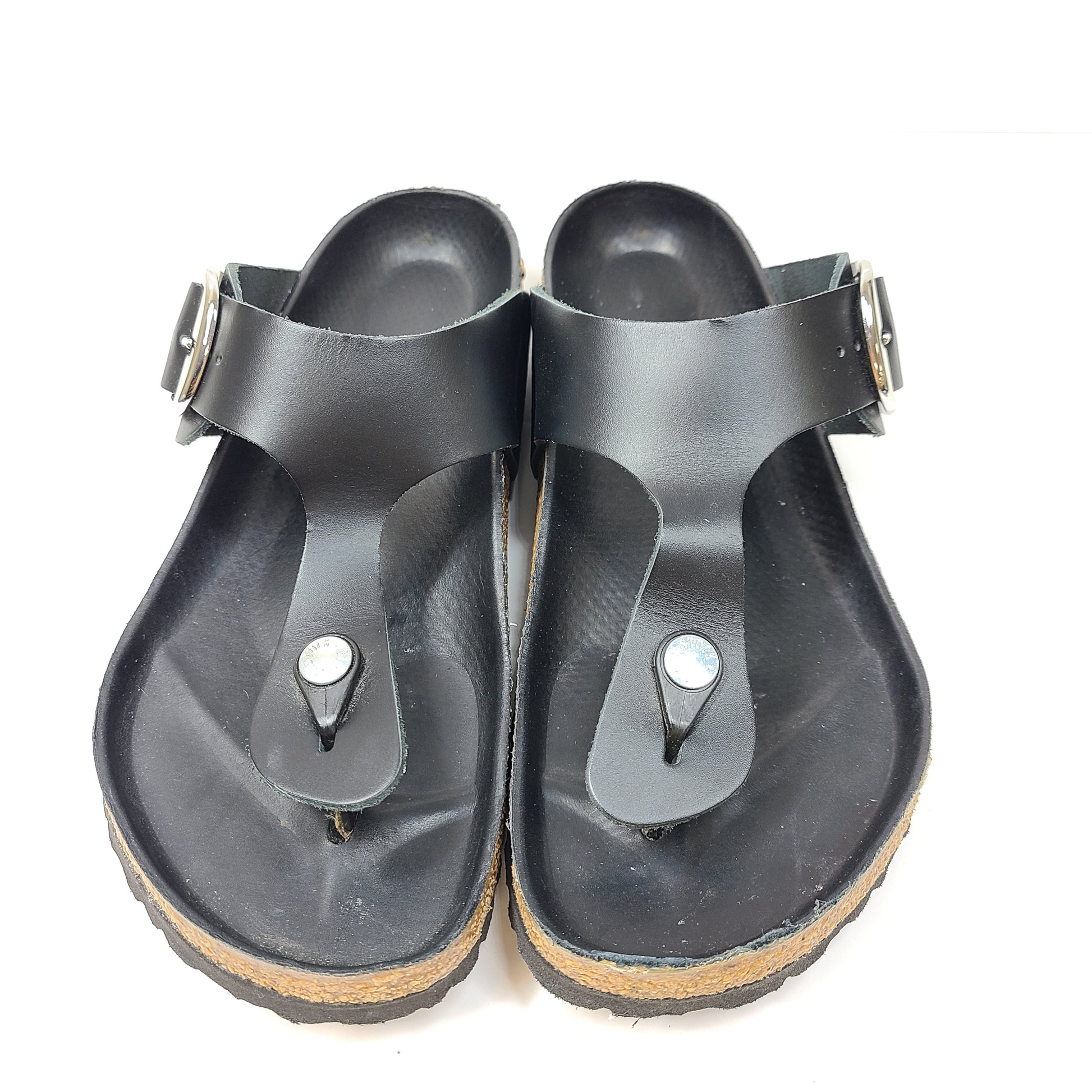 Black Birkenstock sandals size 40 with adjustable straps and contoured cork footbed for lasting comfort.