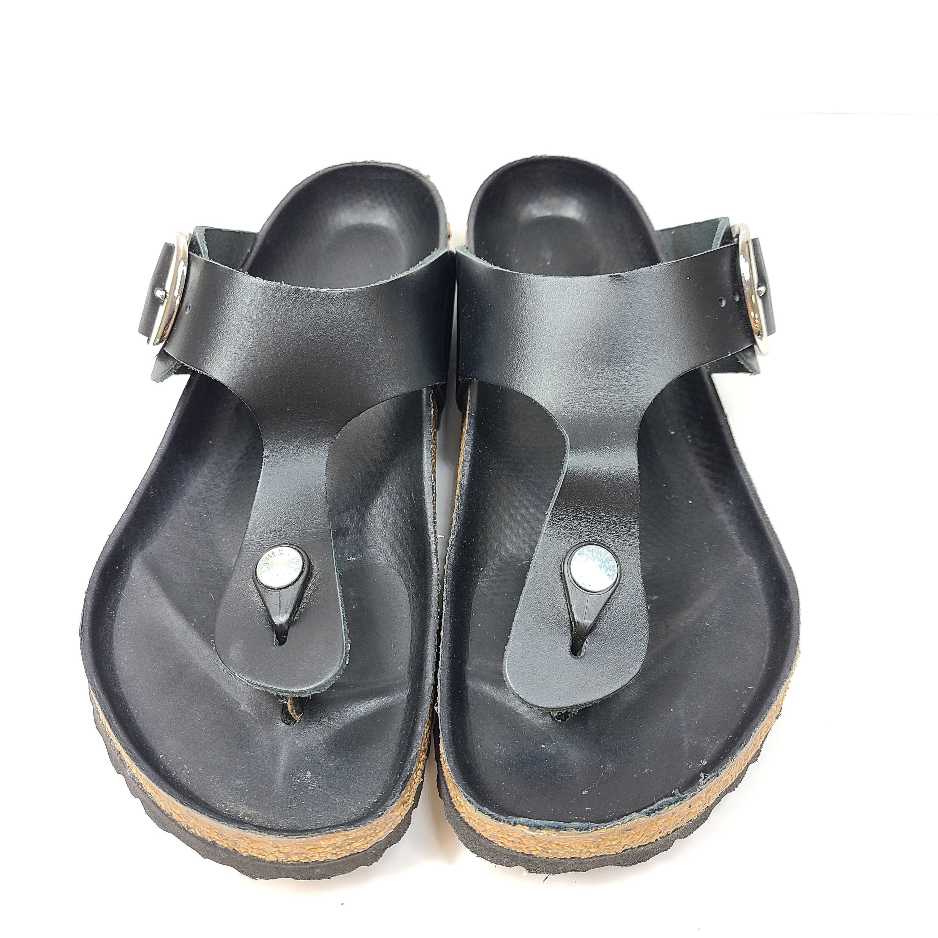 Black Birkenstock sandals size 40 with adjustable straps and contoured cork footbed for lasting comfort.