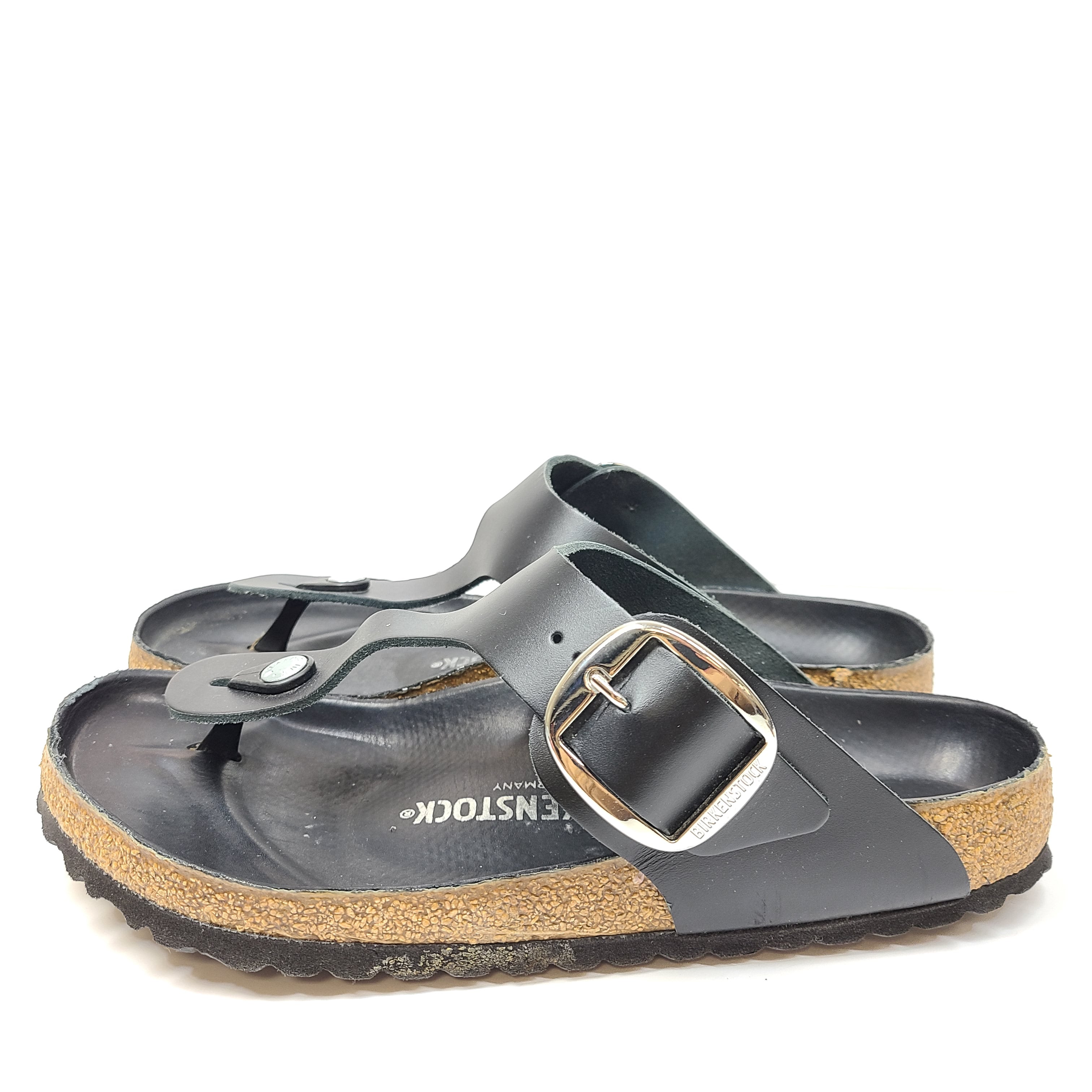 Black Birkenstock sandals size 40 with adjustable straps and contoured cork footbed for lasting comfort.