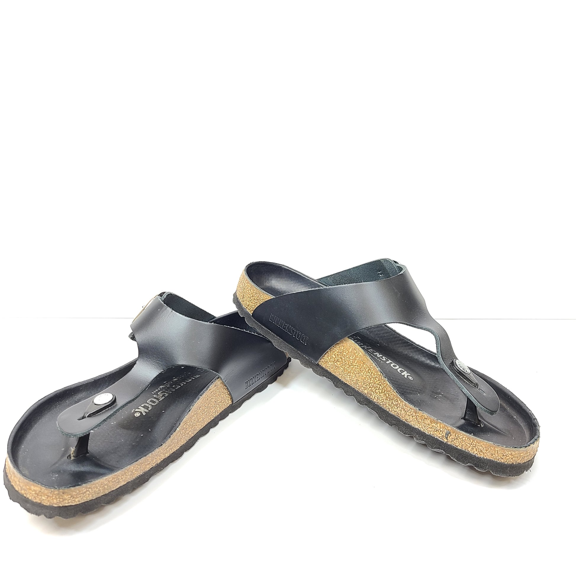 Black Birkenstock sandals size 40 with adjustable straps and contoured cork footbed for lasting comfort.
