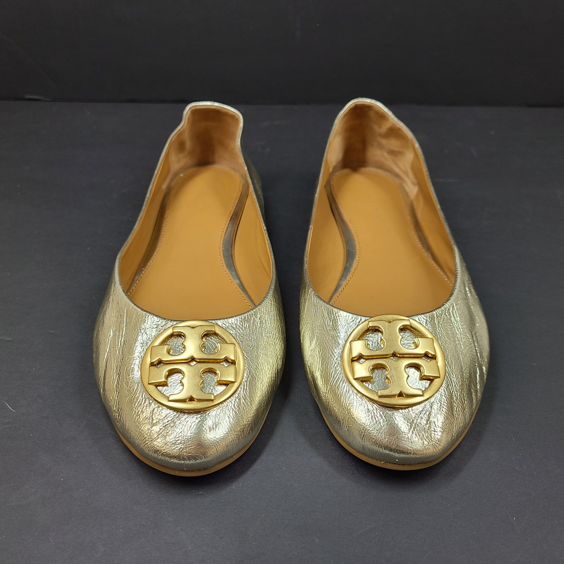 Gold leather Tory Burch flats with rubber outsole and minor creasing, size 8½M.