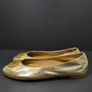 Gold leather Tory Burch flats with rubber outsole and minor creasing, size 8½M.