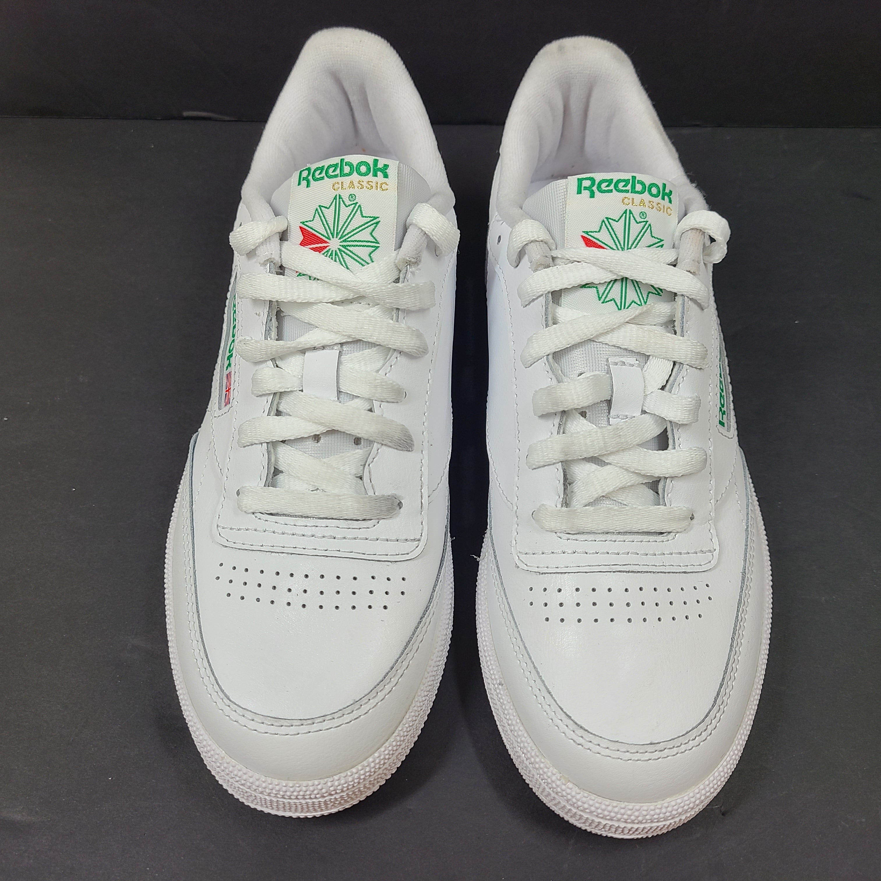 White Reebok Classic low-top sneakers in US size 8 with minimal wear and slight interior lining markings.
