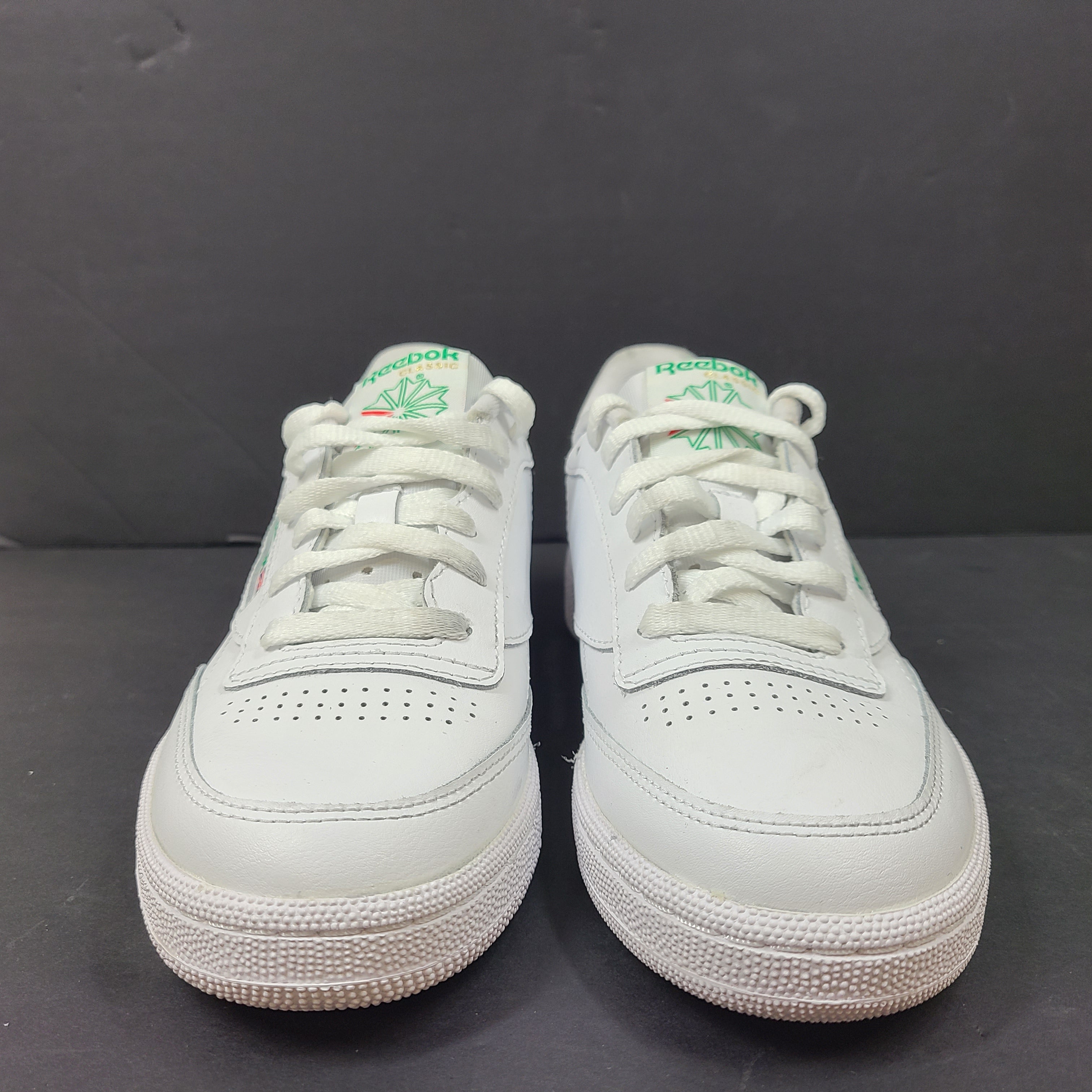 White Reebok Classic low-top sneakers in US size 8 with minimal wear and slight interior lining markings.