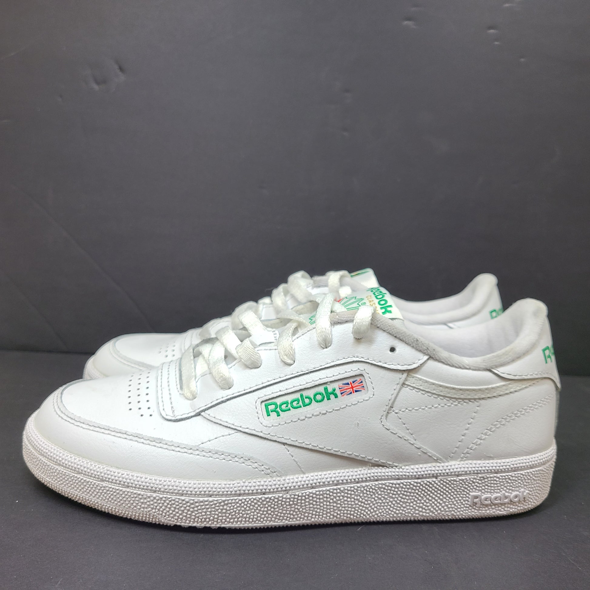 White Reebok Classic low-top sneakers in US size 8 with minimal wear and slight interior lining markings.