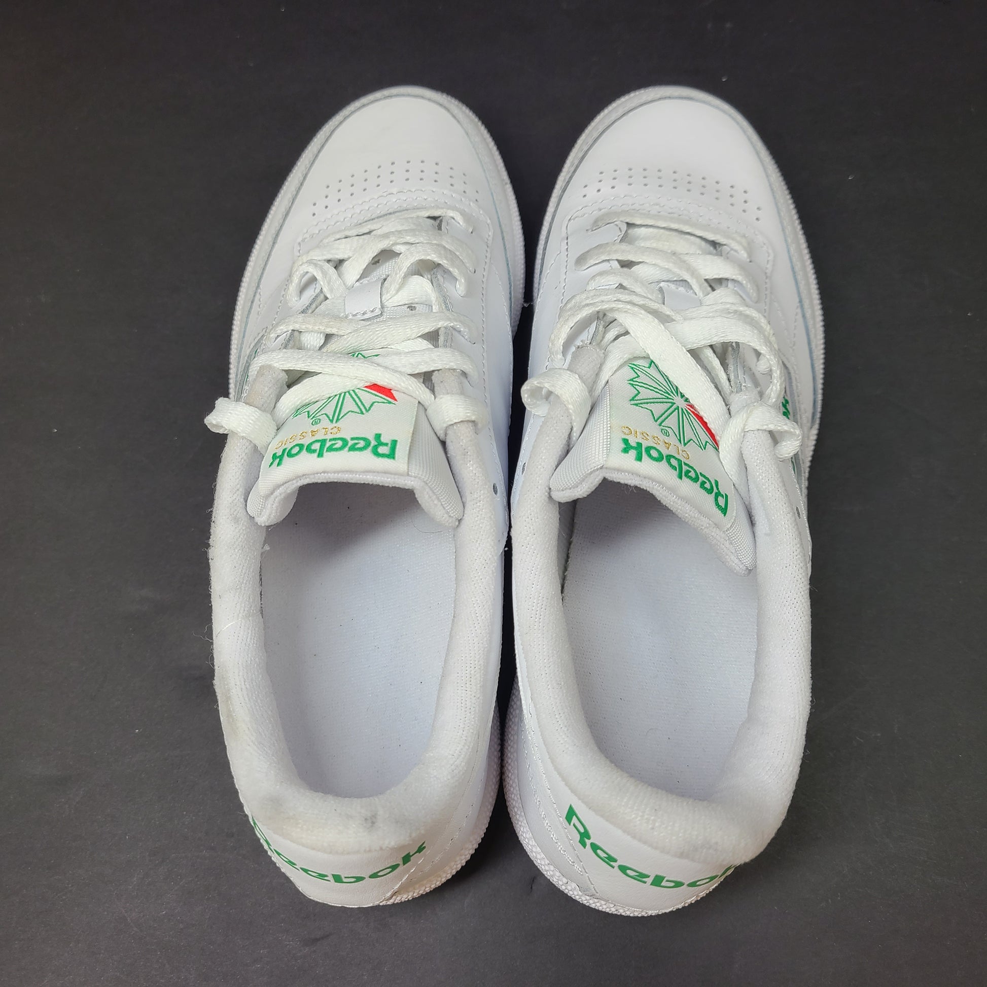 White Reebok Classic low-top sneakers in US size 8 with minimal wear and slight interior lining markings.