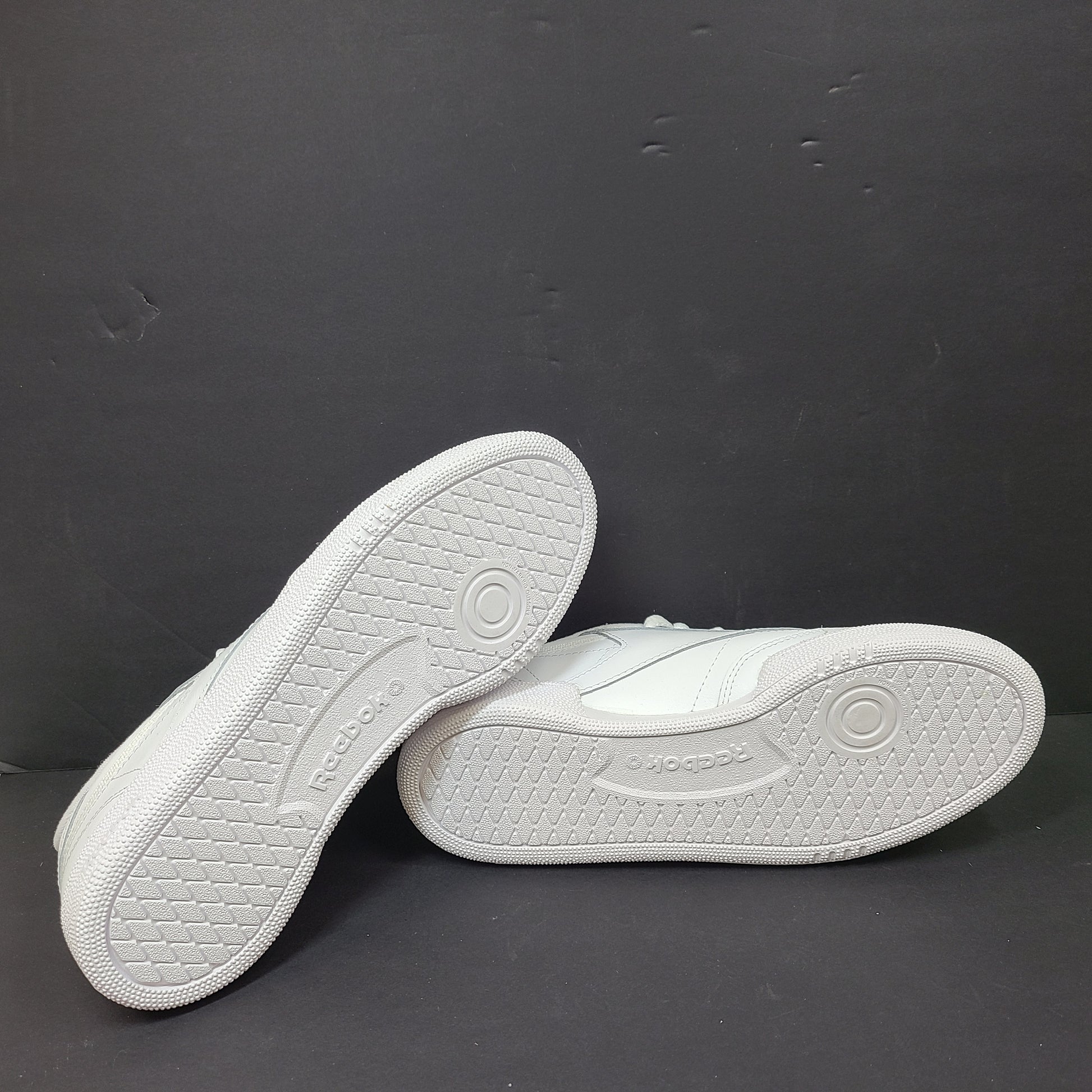 White Reebok Classic low-top sneakers in US size 8 with minimal wear and slight interior lining markings.