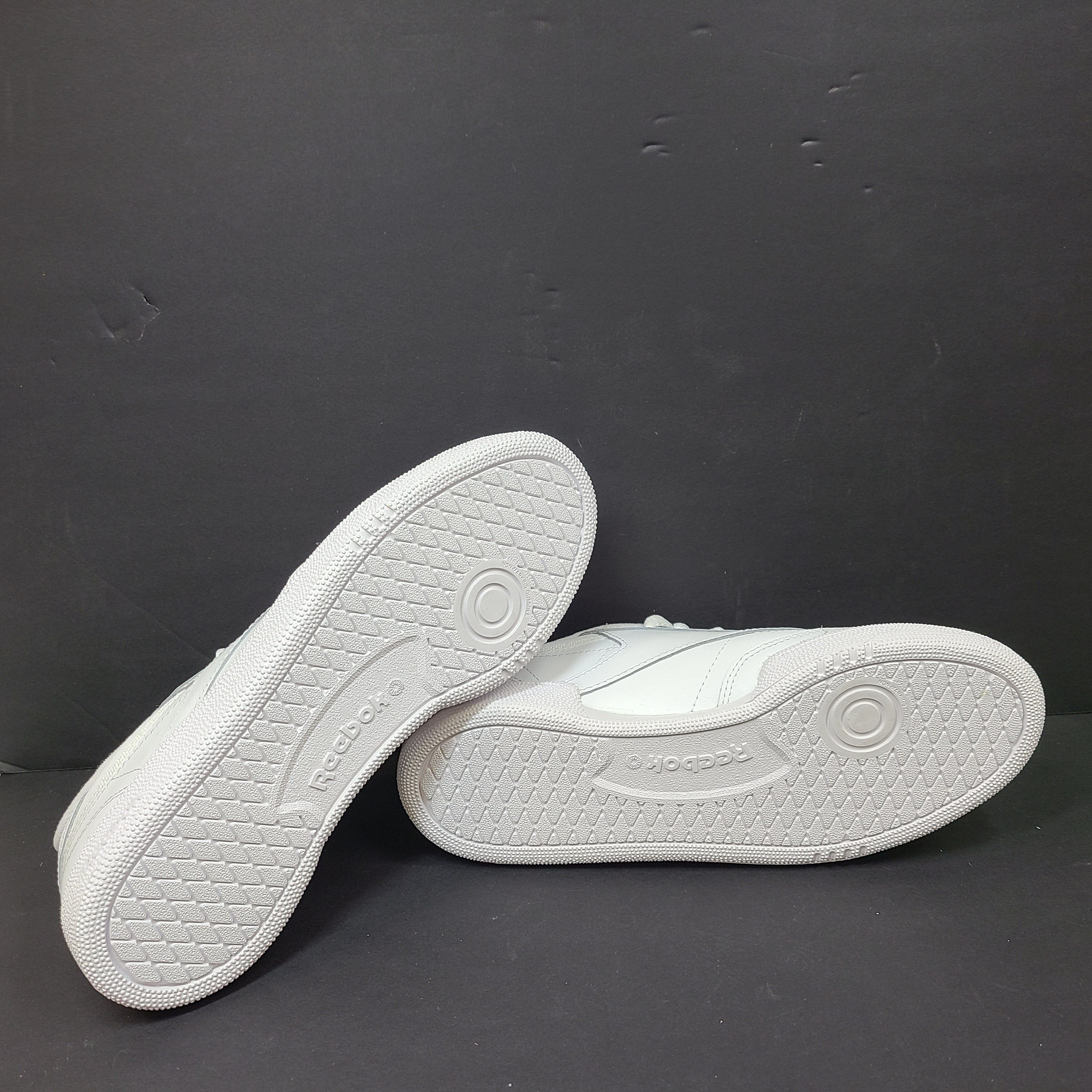 White Reebok Classic low-top sneakers in US size 8 with minimal wear and slight interior lining markings.