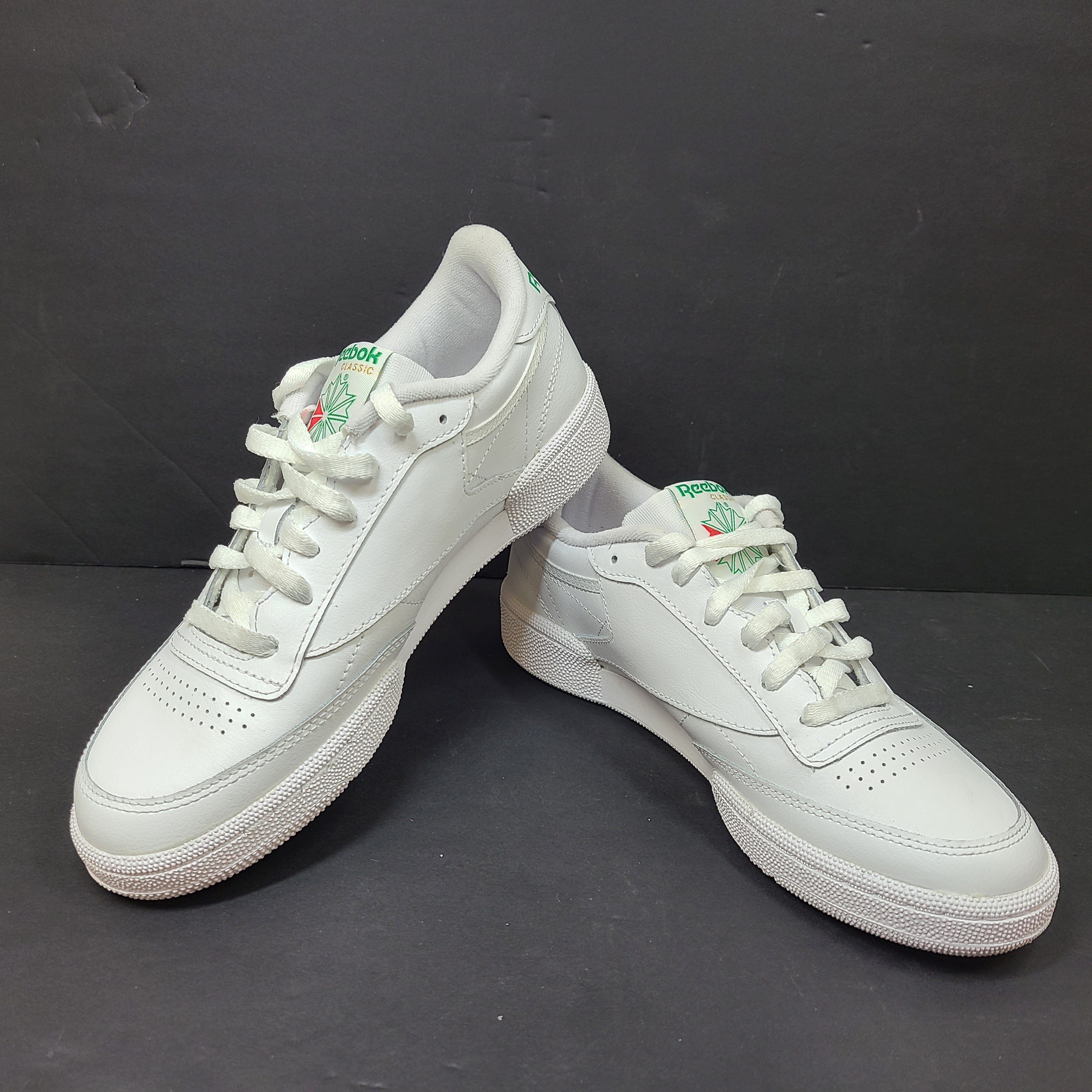 White Reebok Classic low-top sneakers in US size 8 with minimal wear and slight interior lining markings.