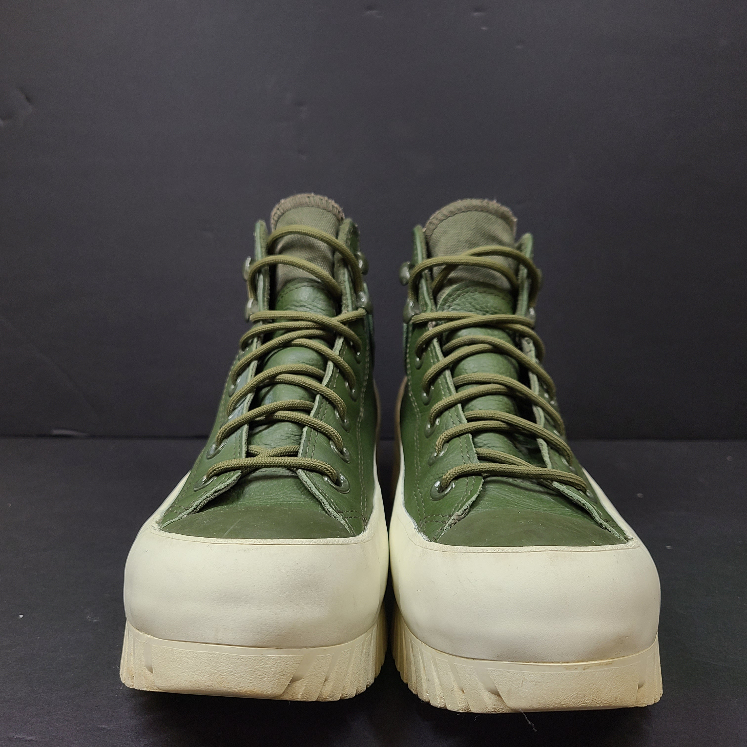 Olive and white Converse All Star Counter Climate waterproof boots with lugged rubber outsoles and leather upper.