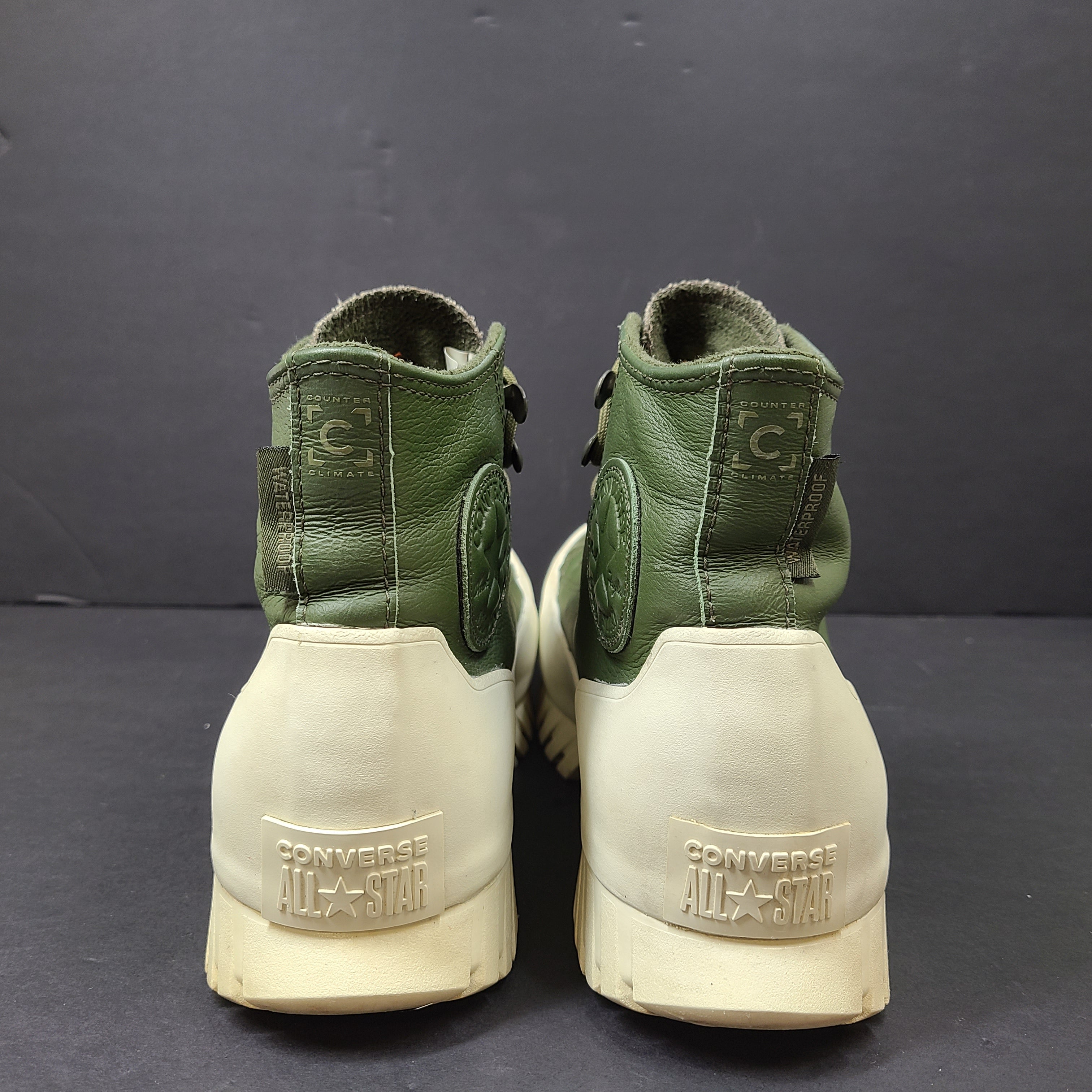 Olive and white Converse All Star Counter Climate waterproof boots with lugged rubber outsoles and leather upper.