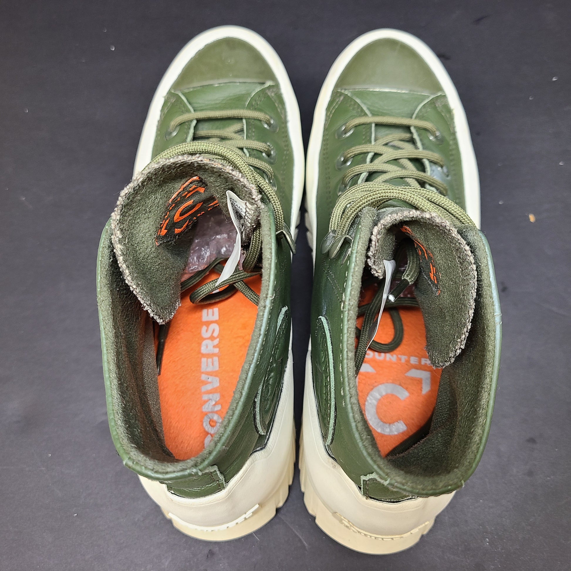 Olive and white Converse All Star Counter Climate waterproof boots with lugged rubber outsoles and leather upper.