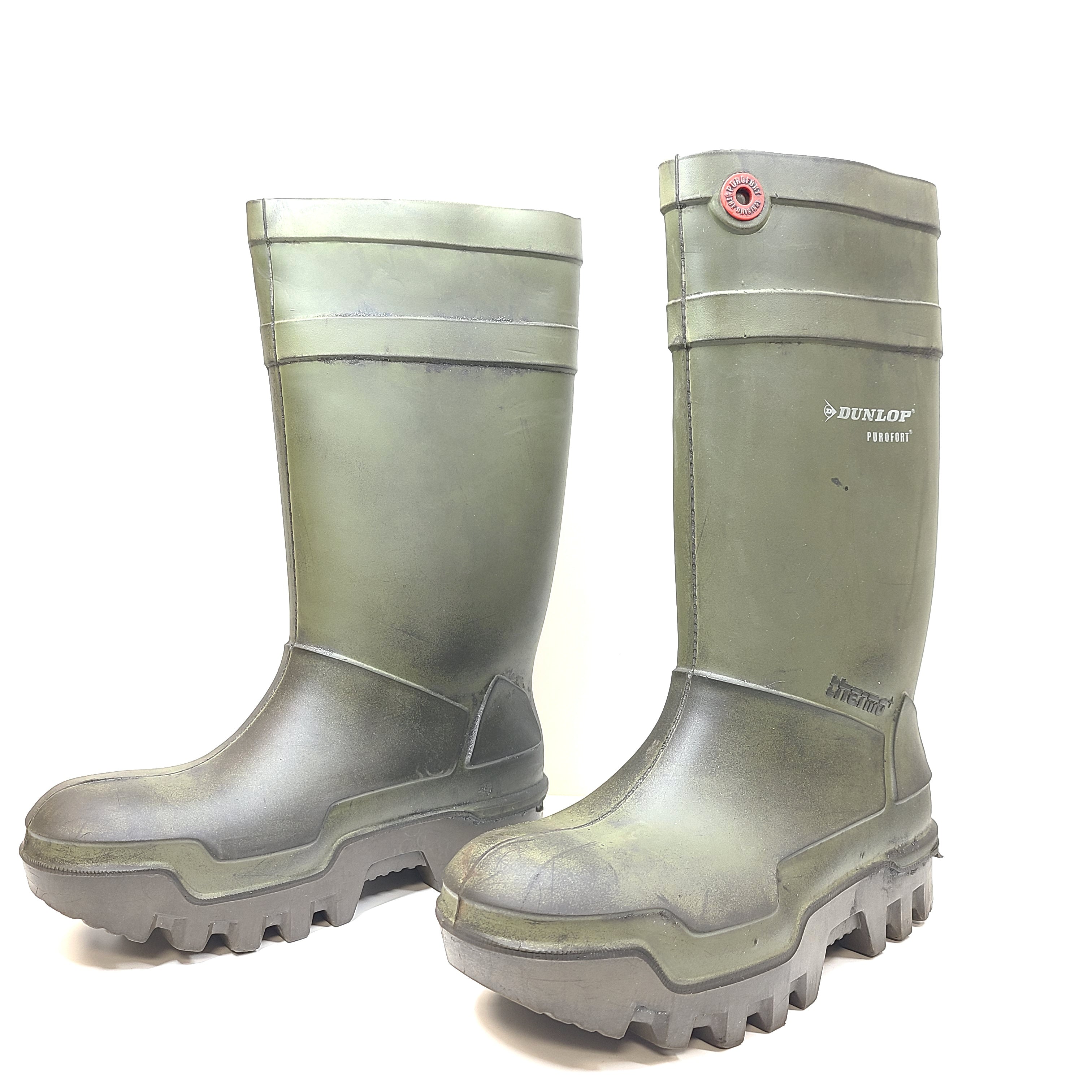 Sturdy green Dunlop Purofort M/SD safety boots with a textured sole and moderate wear.