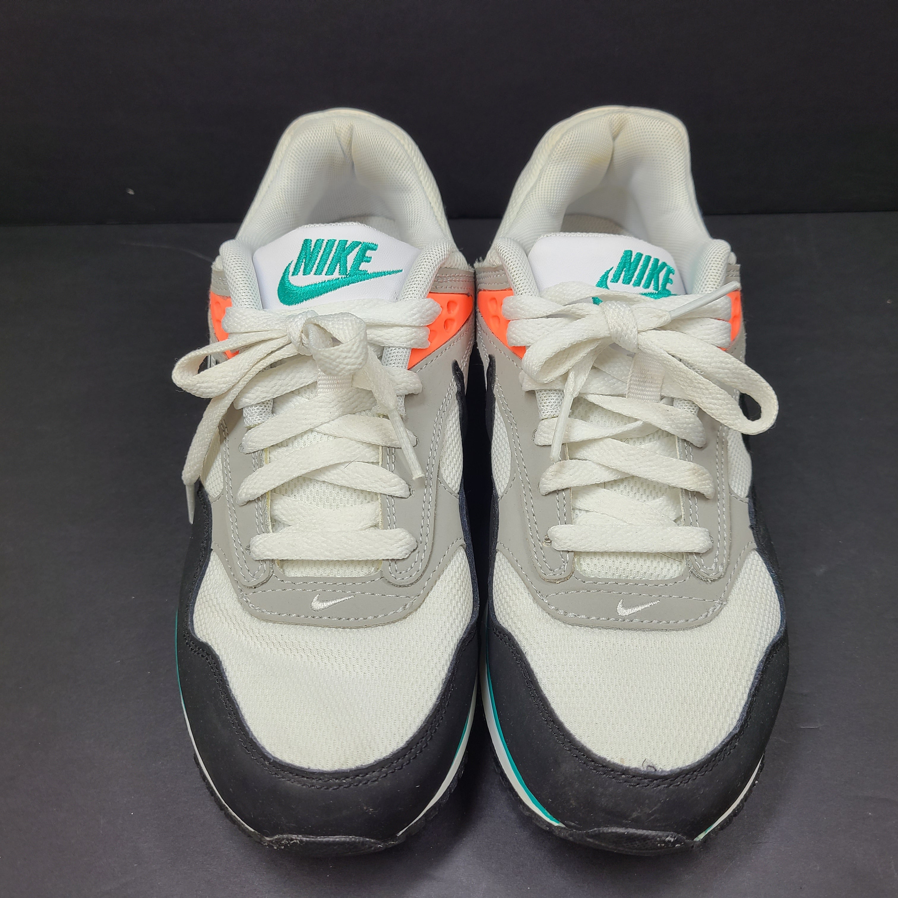 Nike Air Max Correlate in white, black and orange with Air Max cushioning and a low-top silhouette.