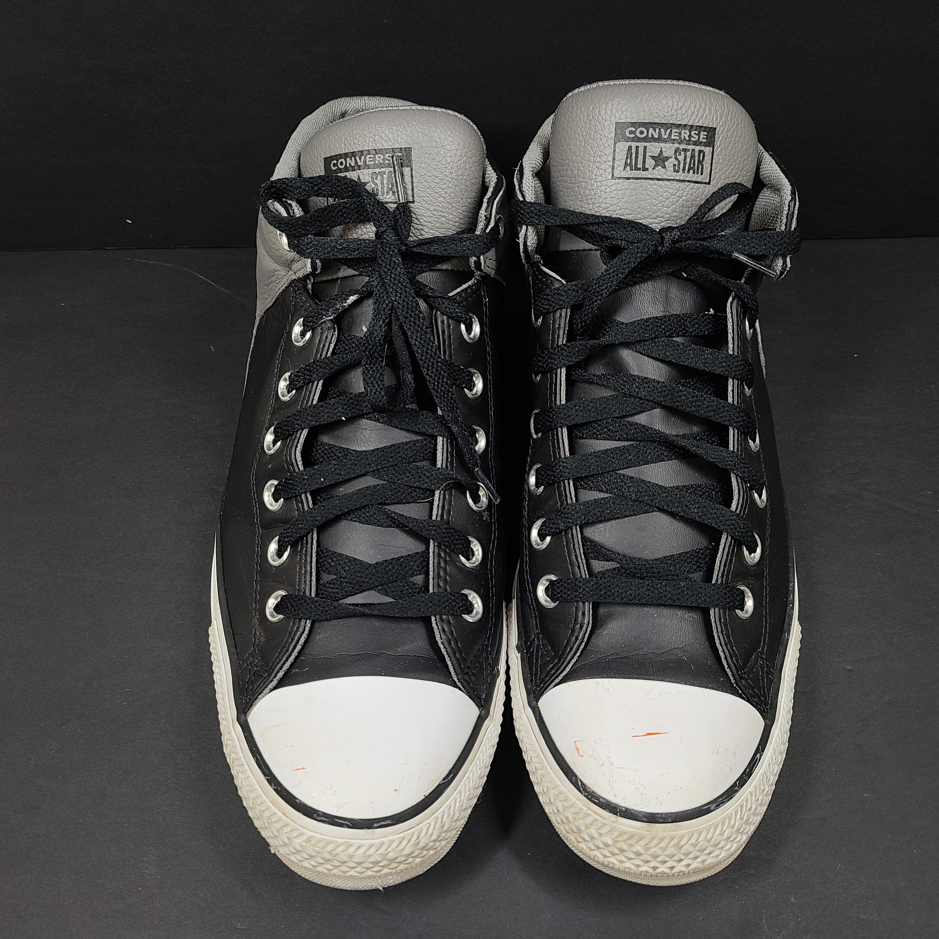 Black and grey Converse All Star high-top sneakers in men's size 12 with rubber outsoles and textile lining.