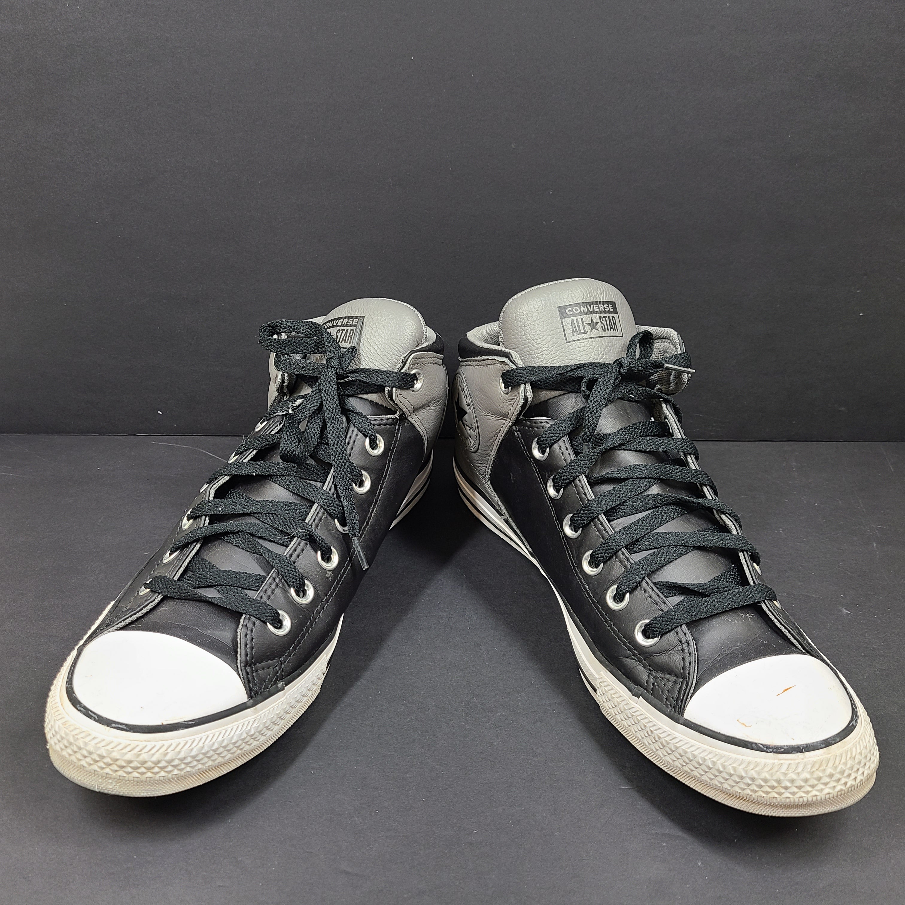 Black and grey Converse All Star high-top sneakers in men's size 12 with rubber outsoles and textile lining.