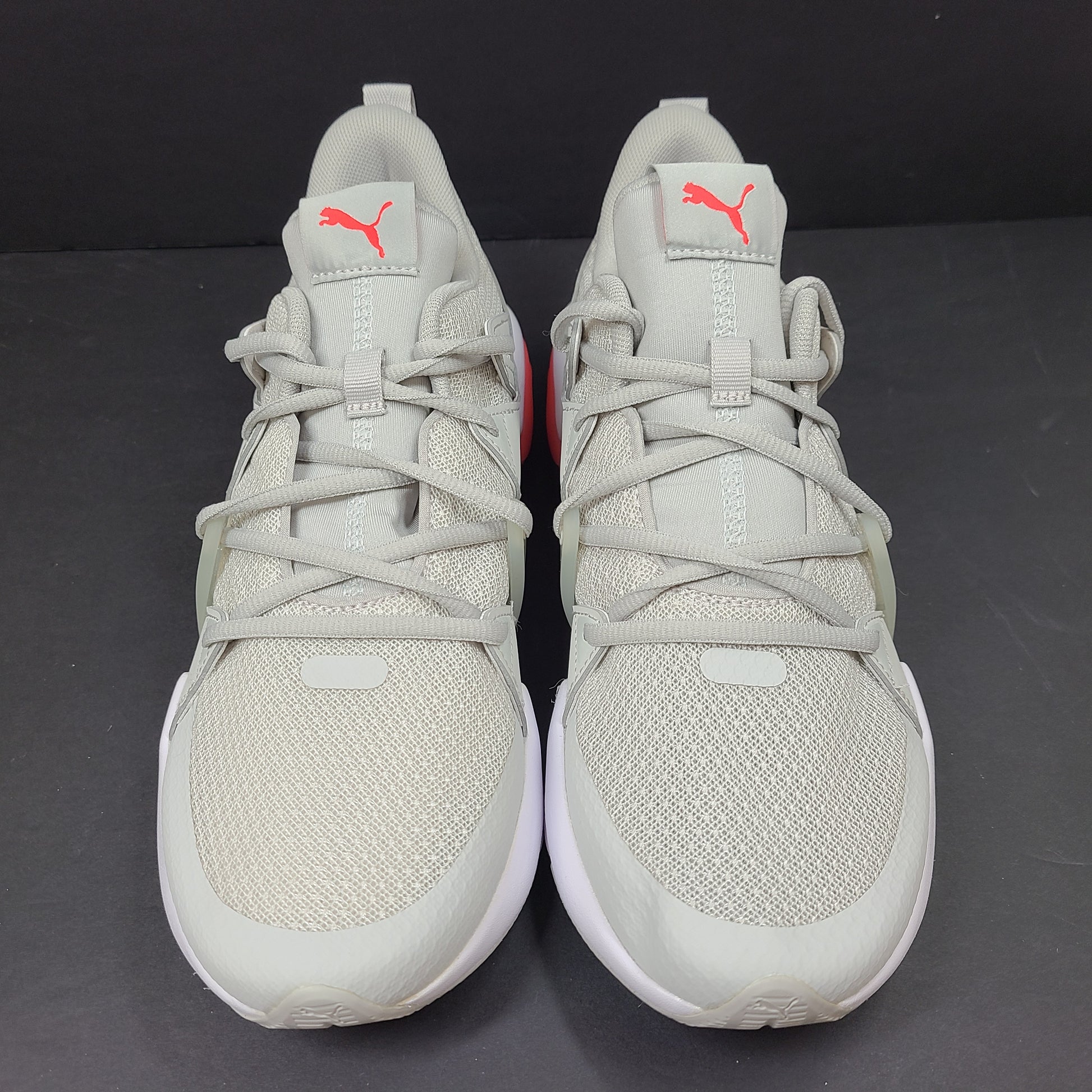 Puma SOFTFOAM women's sneaker in light gray and coral with cushioned midsole for everyday comfort.