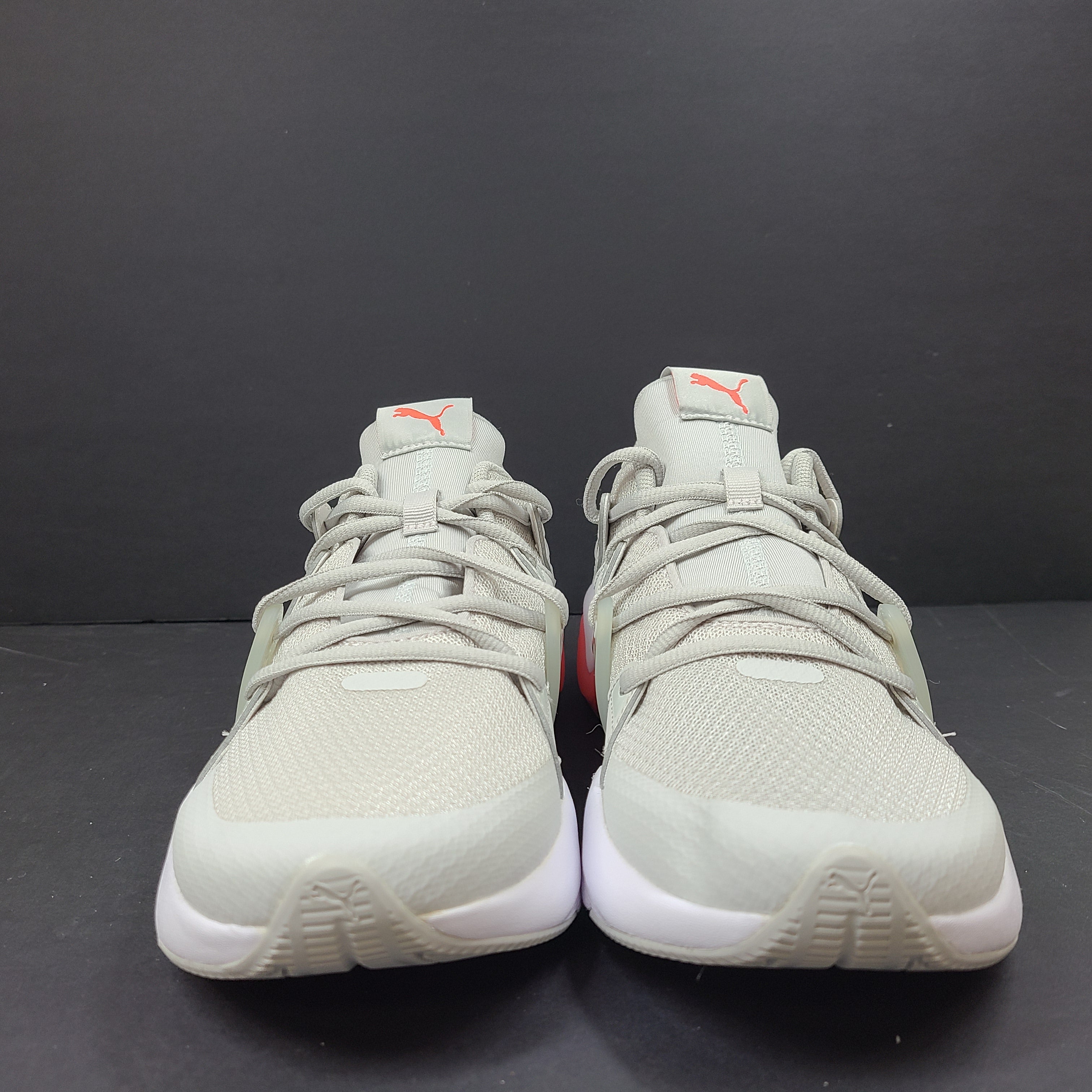 Puma SOFTFOAM women's sneaker in light gray and coral with cushioned midsole for everyday comfort.