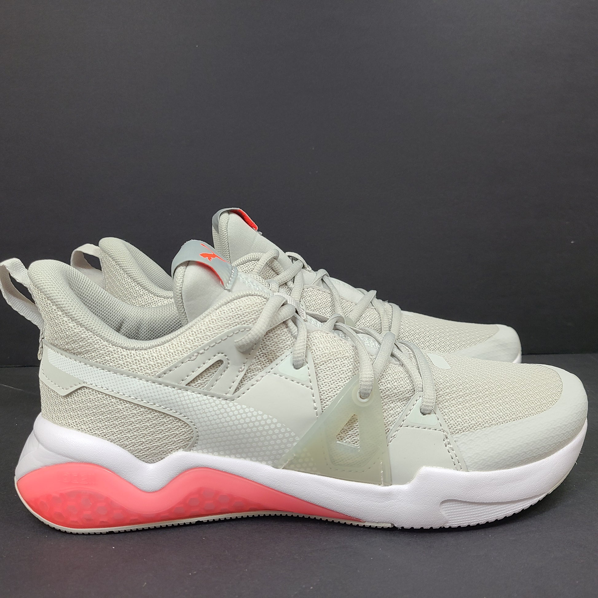 Puma SOFTFOAM women's sneaker in light gray and coral with cushioned midsole for everyday comfort.