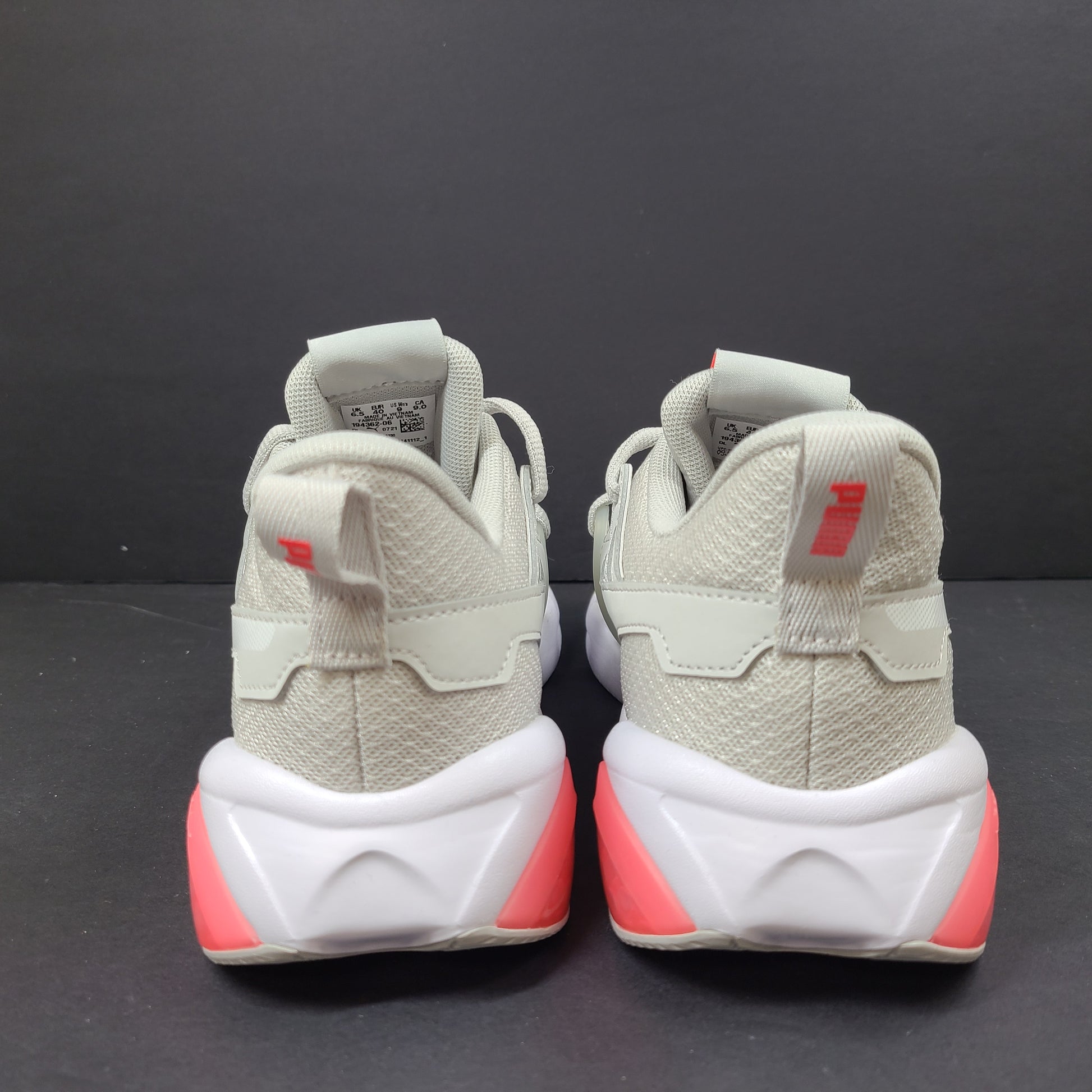 Puma SOFTFOAM women's sneaker in light gray and coral with cushioned midsole for everyday comfort.