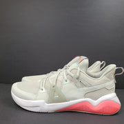 Puma SOFTFOAM women's sneaker in light gray and coral with cushioned midsole for everyday comfort.