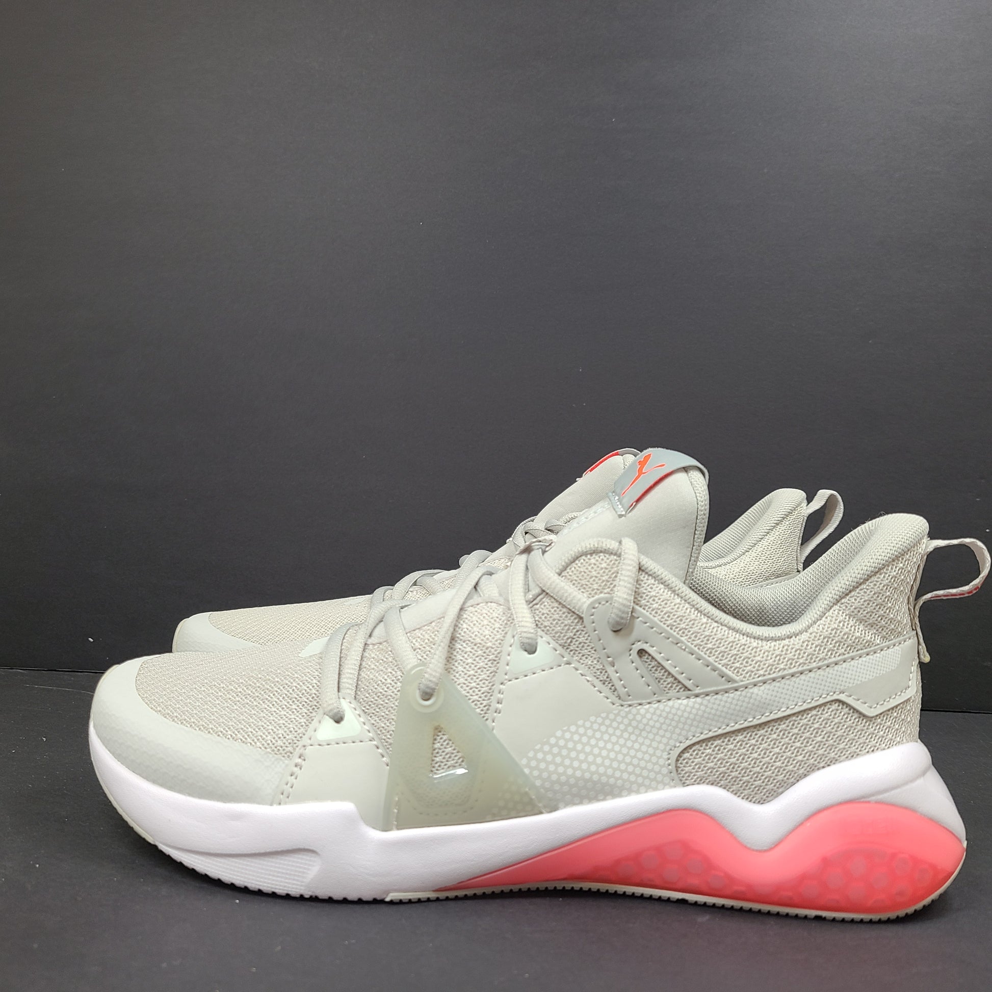 Puma SOFTFOAM women's sneaker in light gray and coral with cushioned midsole for everyday comfort.