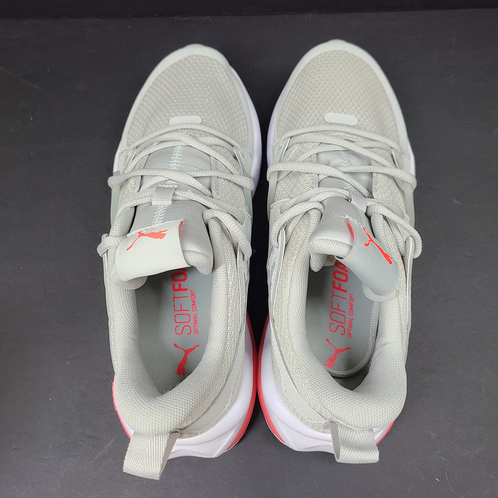 Puma SOFTFOAM women's sneaker in light gray and coral with cushioned midsole for everyday comfort.