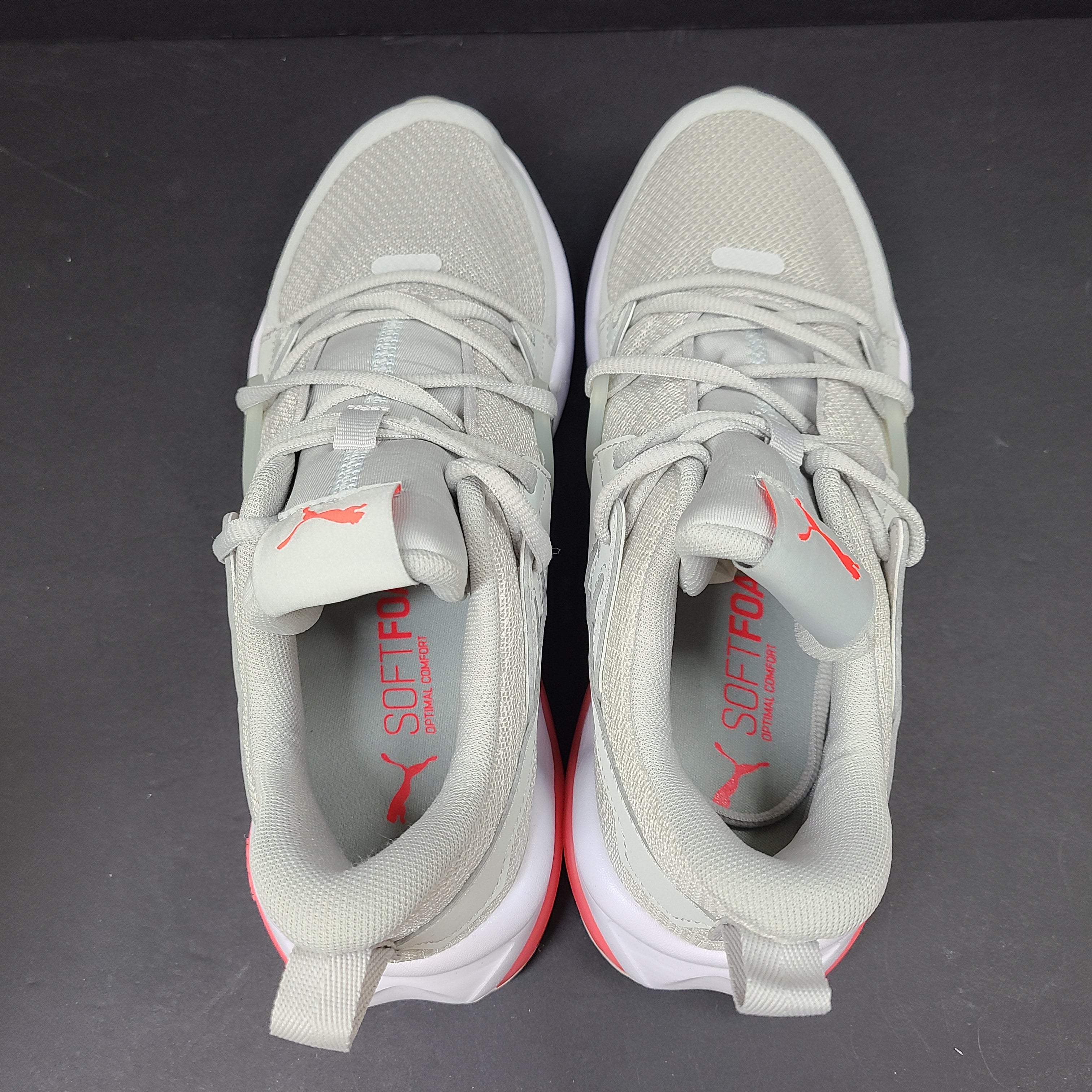 Puma SOFTFOAM women's sneaker in light gray and coral with cushioned midsole for everyday comfort.