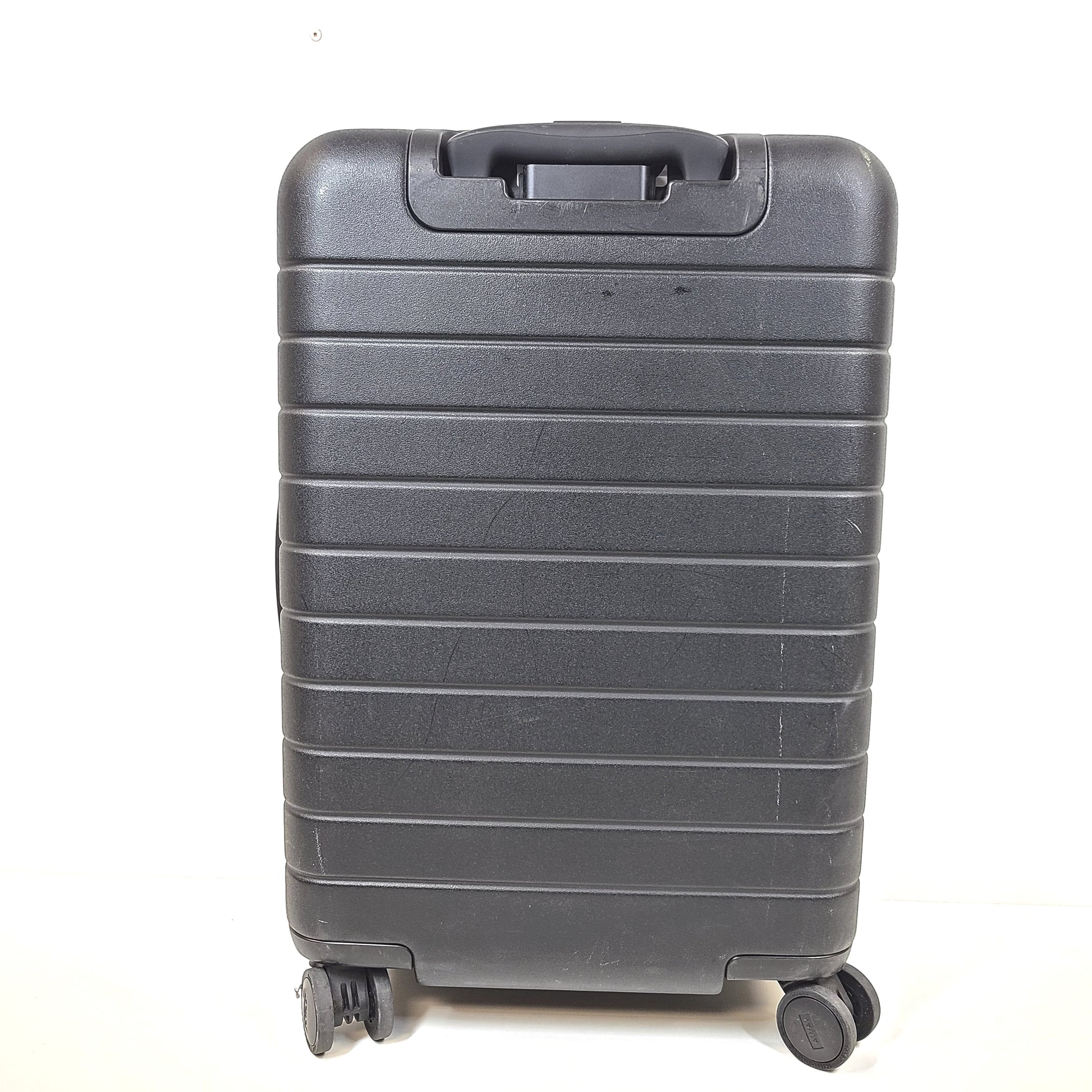 Black Away suitcase with built-in combination lock and organized interior compartments for efficient packing.