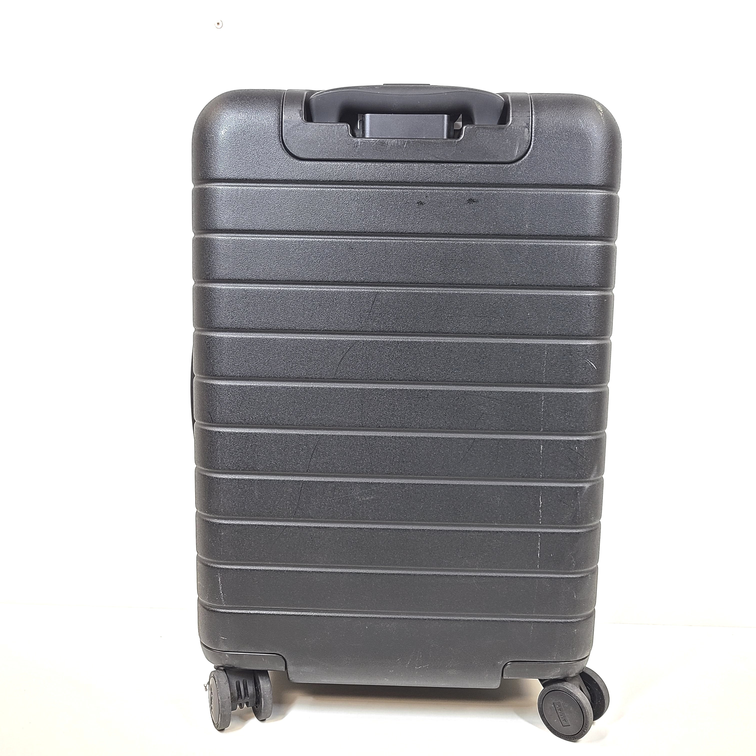 Black Away suitcase with built-in combination lock and organized interior compartments for efficient packing.