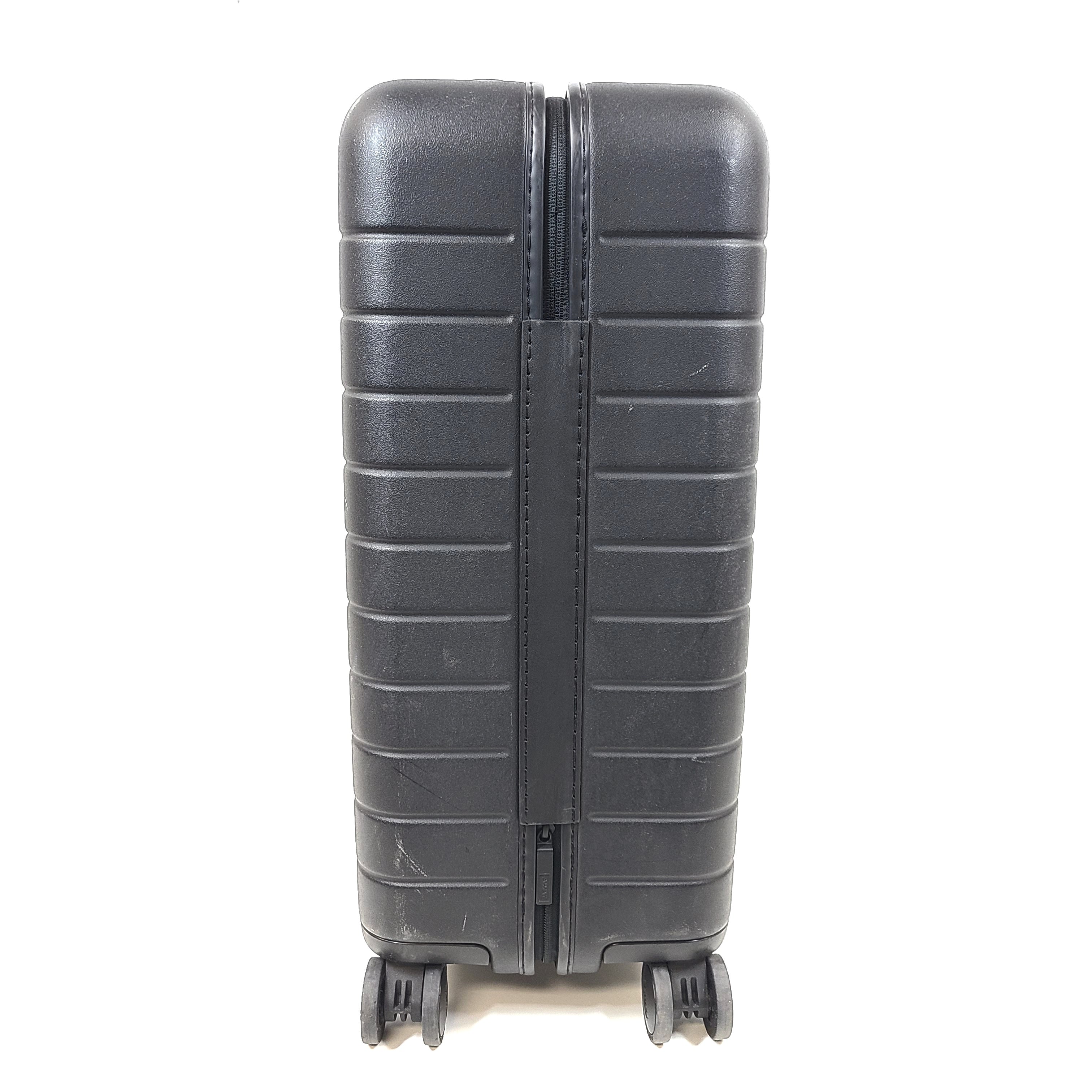 Black Away suitcase with built-in combination lock and organized interior compartments for efficient packing.