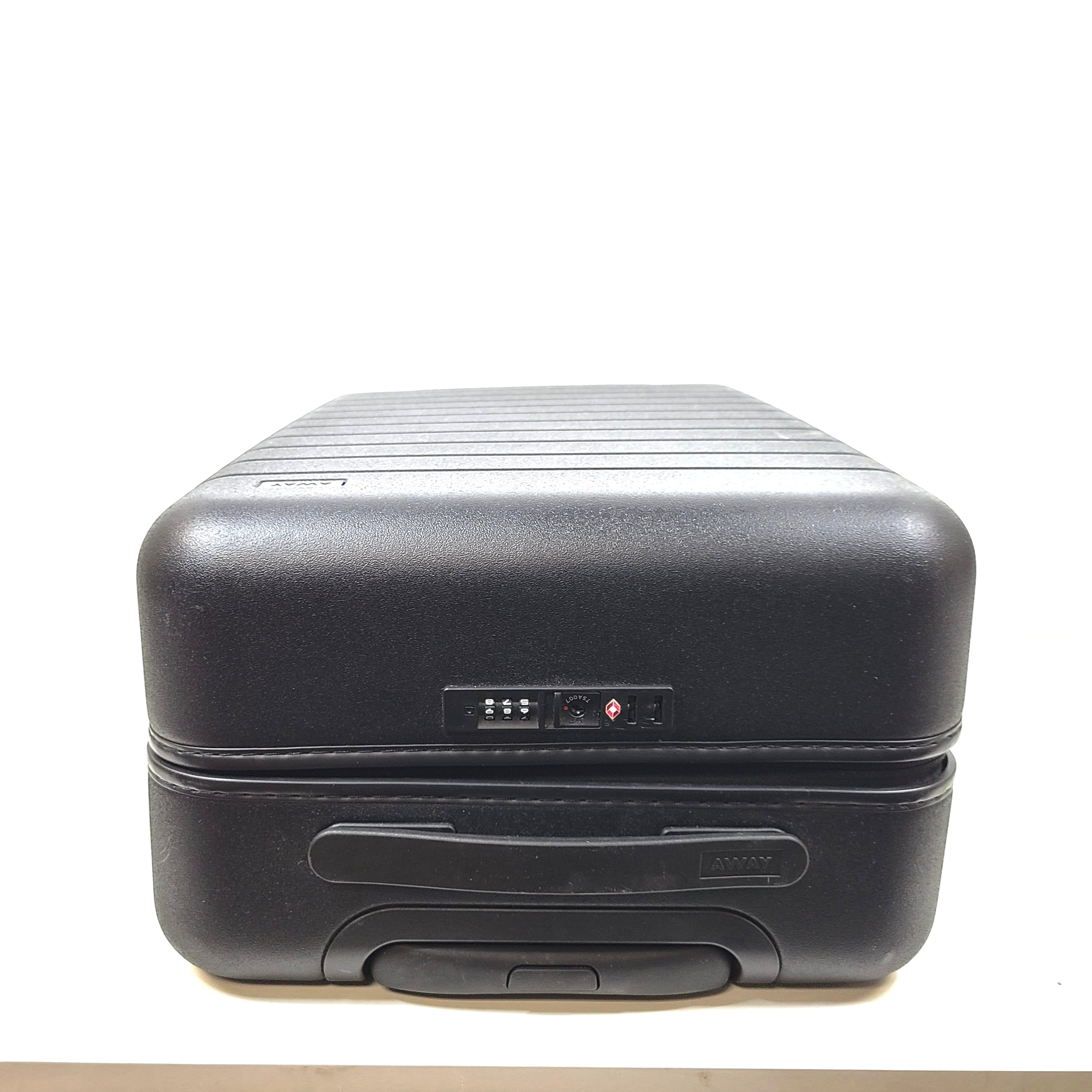 Black Away suitcase with built-in combination lock and organized interior compartments for efficient packing.
