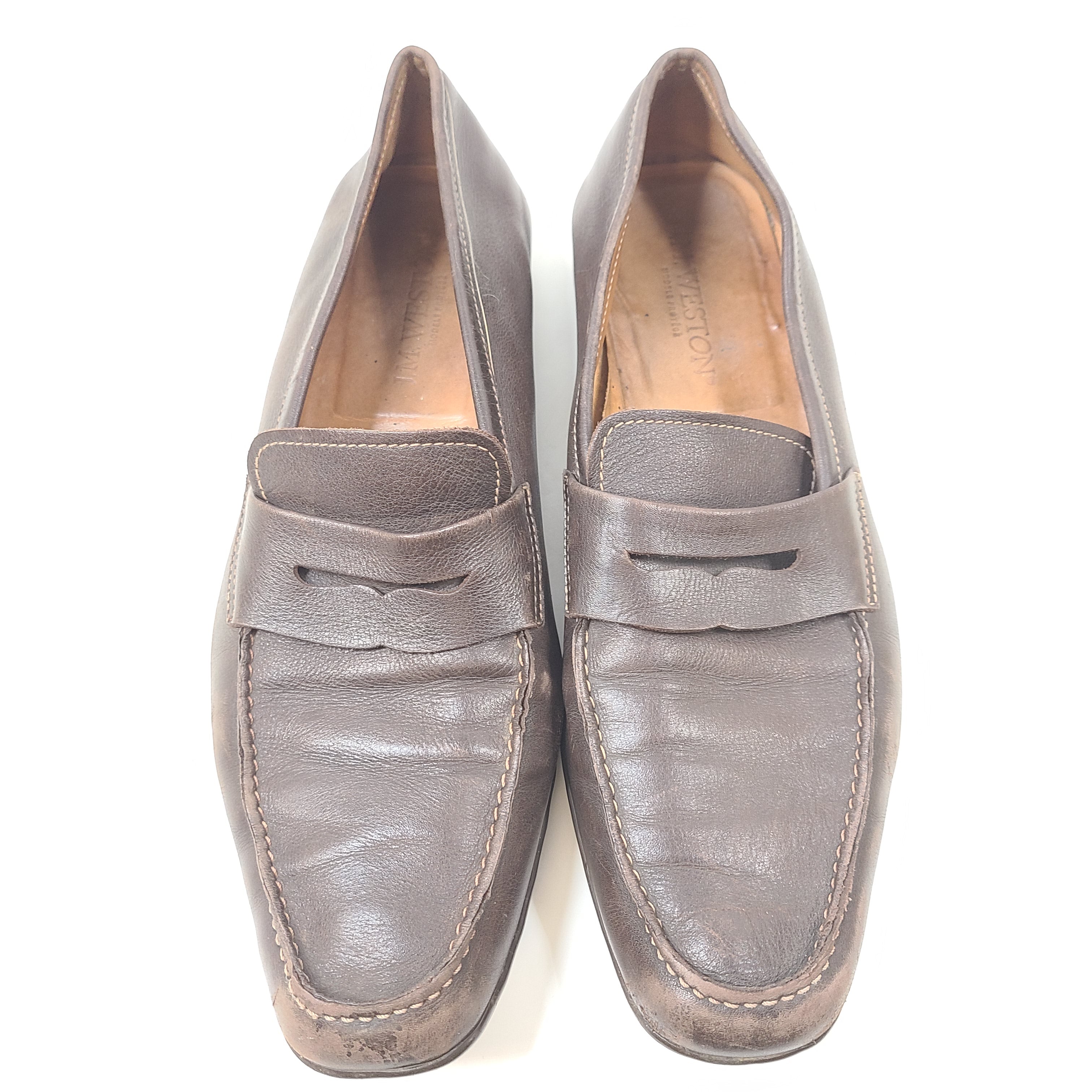Brown leather Johnston & Murphy loafers in men's size 10.5 D with classic slip-on styling.
