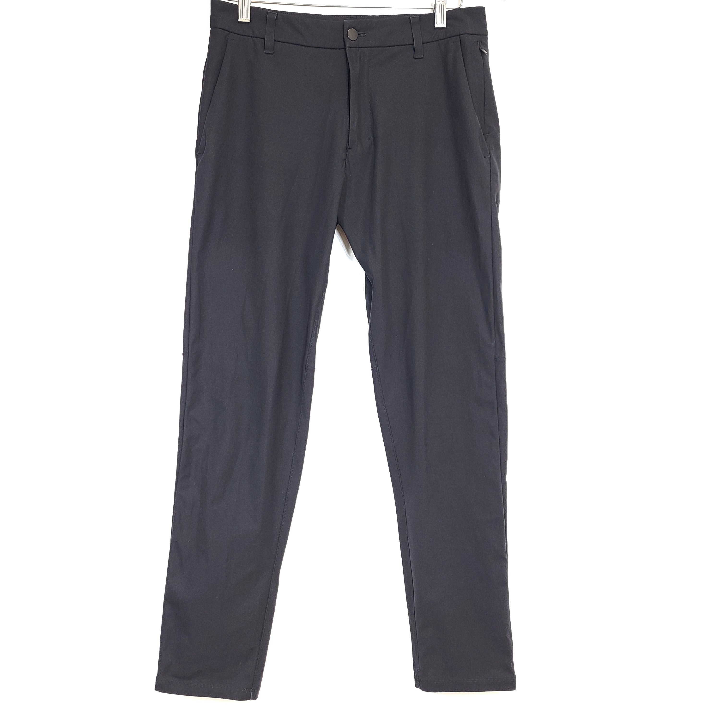Black Lululemon men's pants in size 30 with polyester fabric and branded logo.