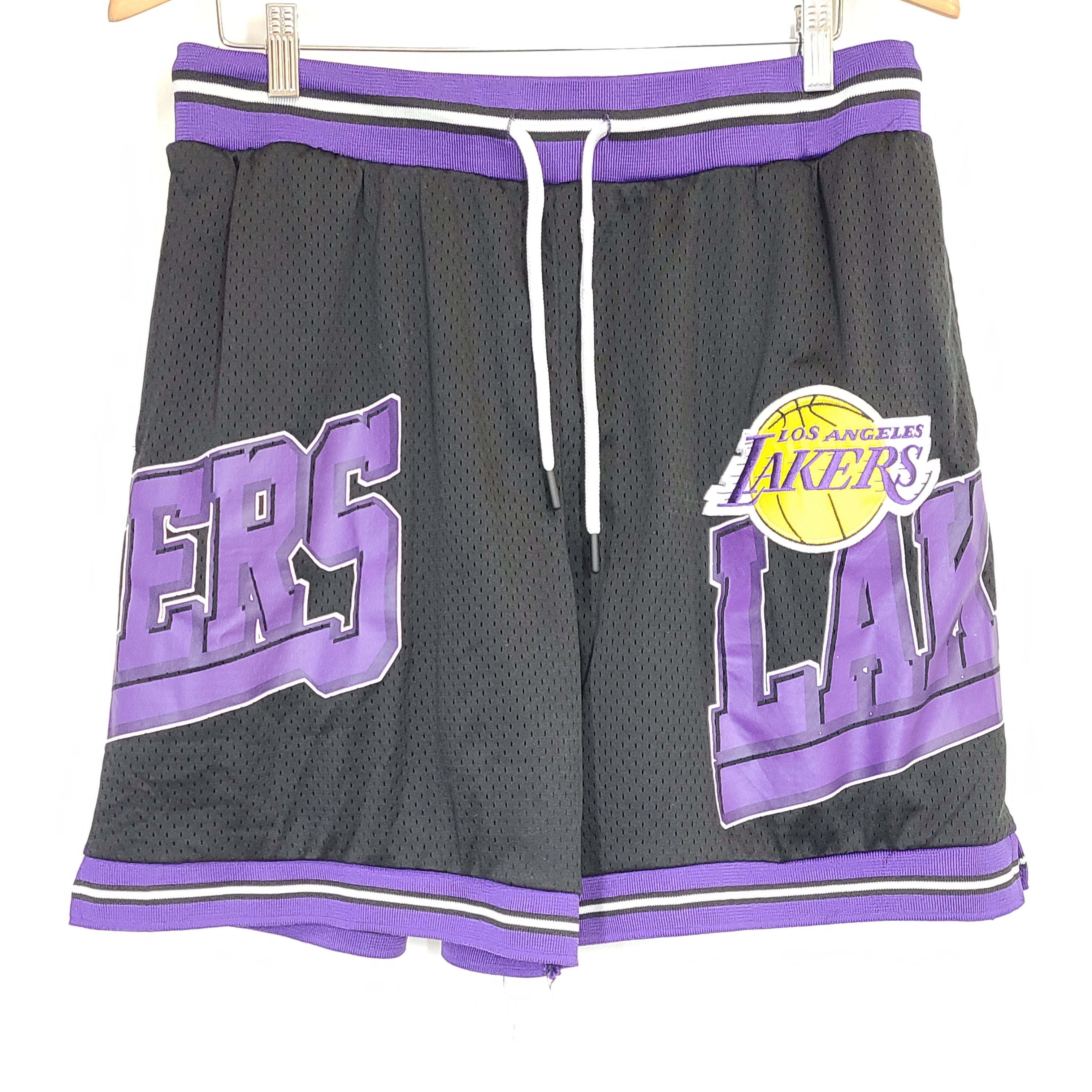 Black and purple Los Angeles Lakers basketball shorts by Ultra Game with team and NBA logos.