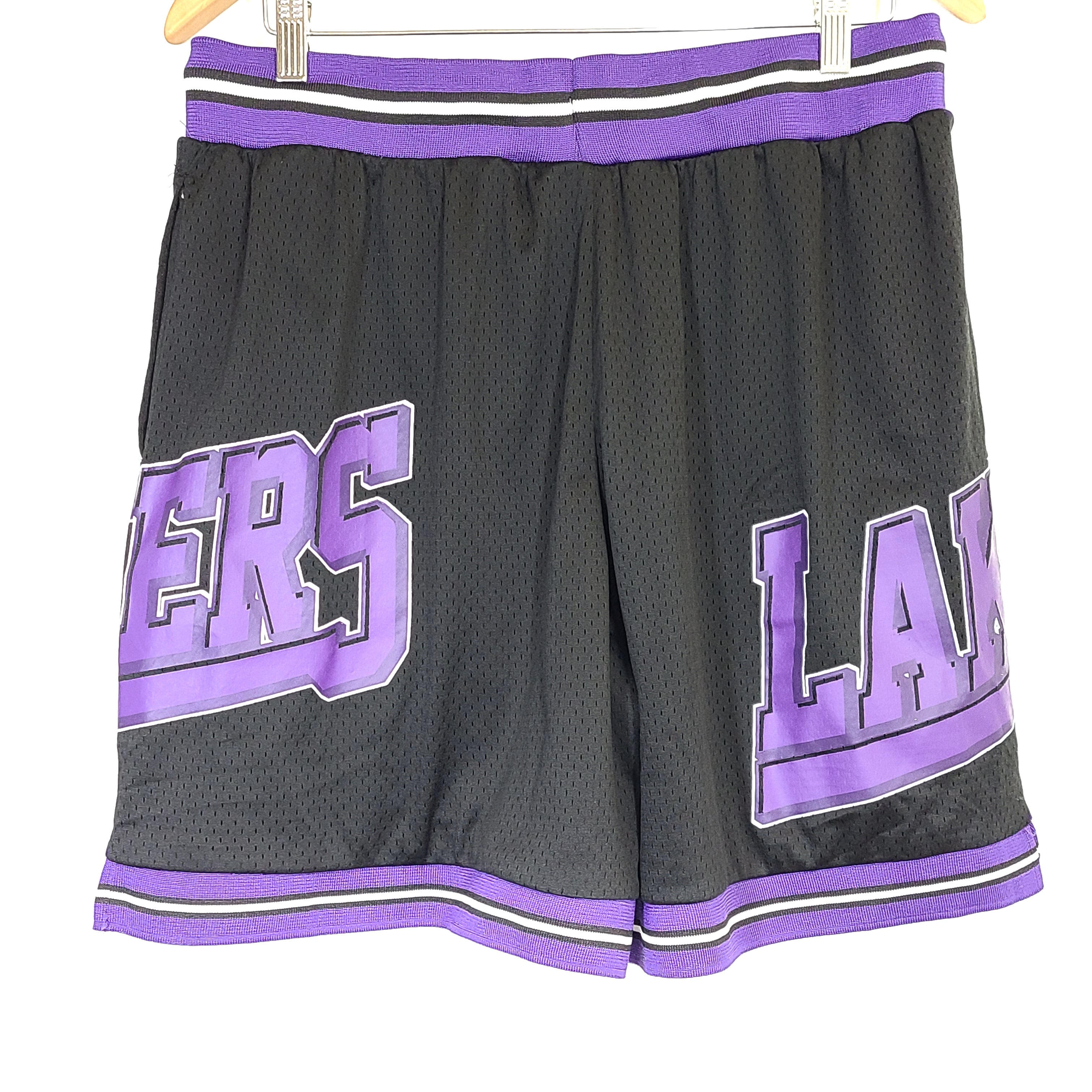 Black and purple Los Angeles Lakers basketball shorts by Ultra Game with team and NBA logos.