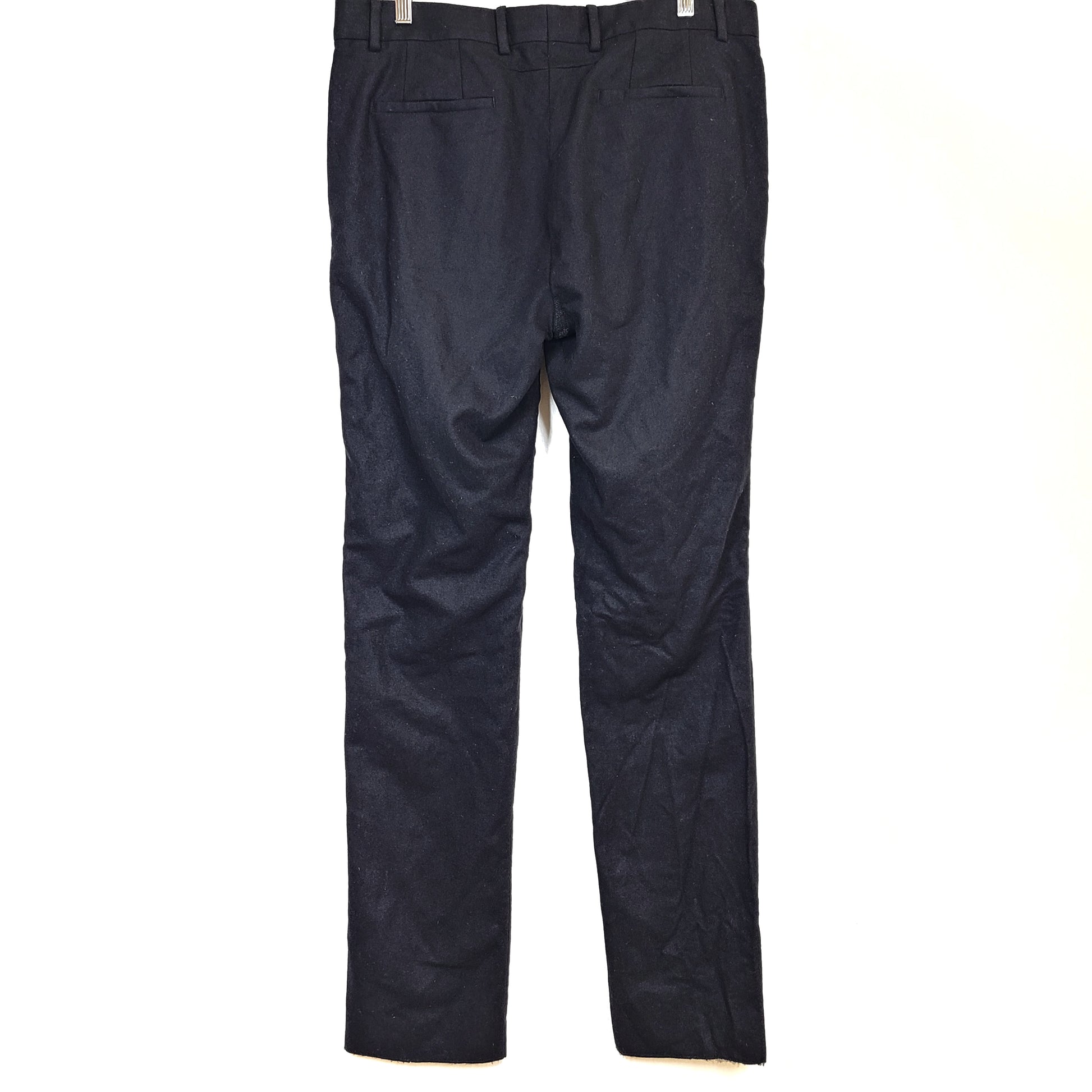 Black Givenchy wool trousers, size 52, with tailored straight-leg styling.