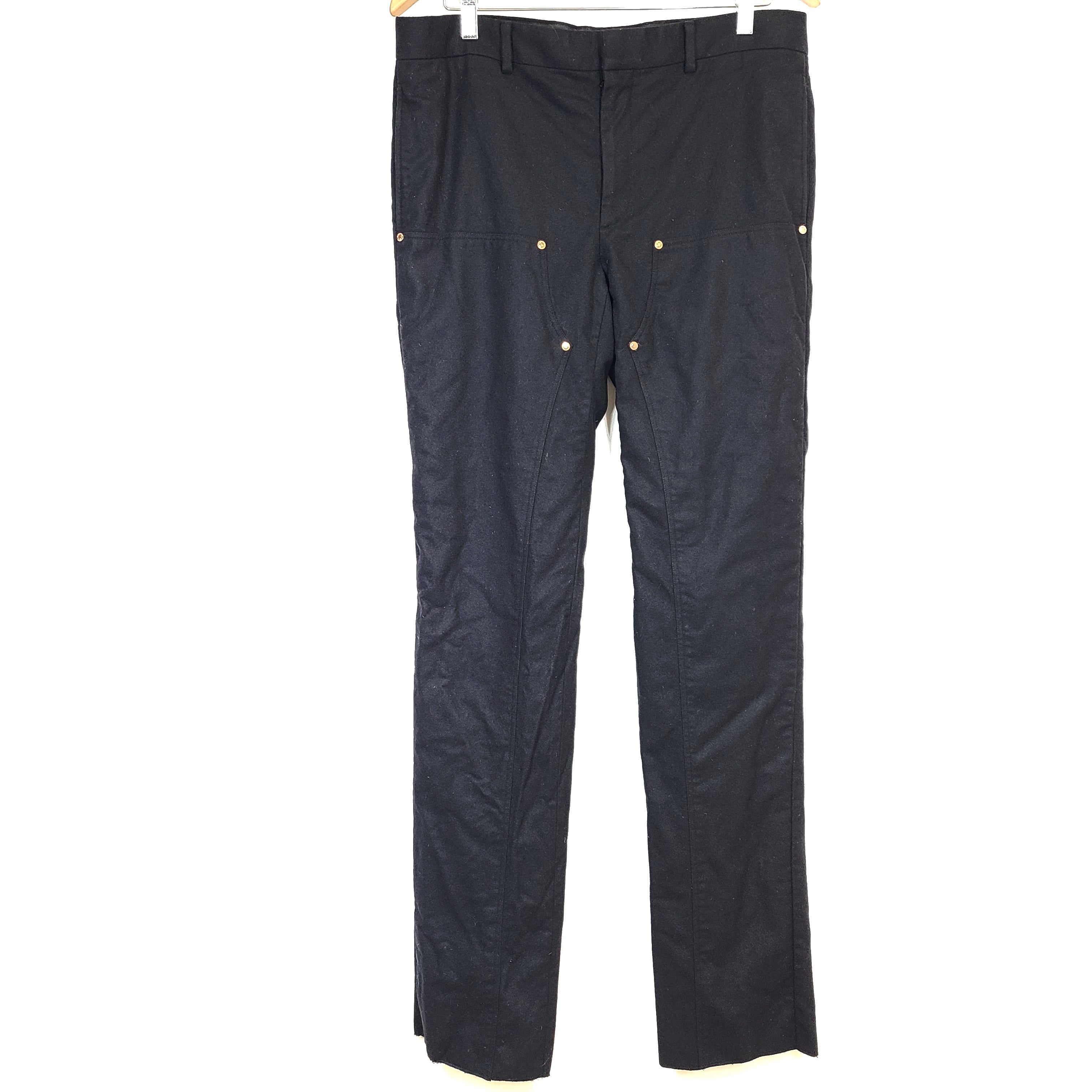 Black Givenchy wool trousers, size 52, with tailored straight-leg styling.