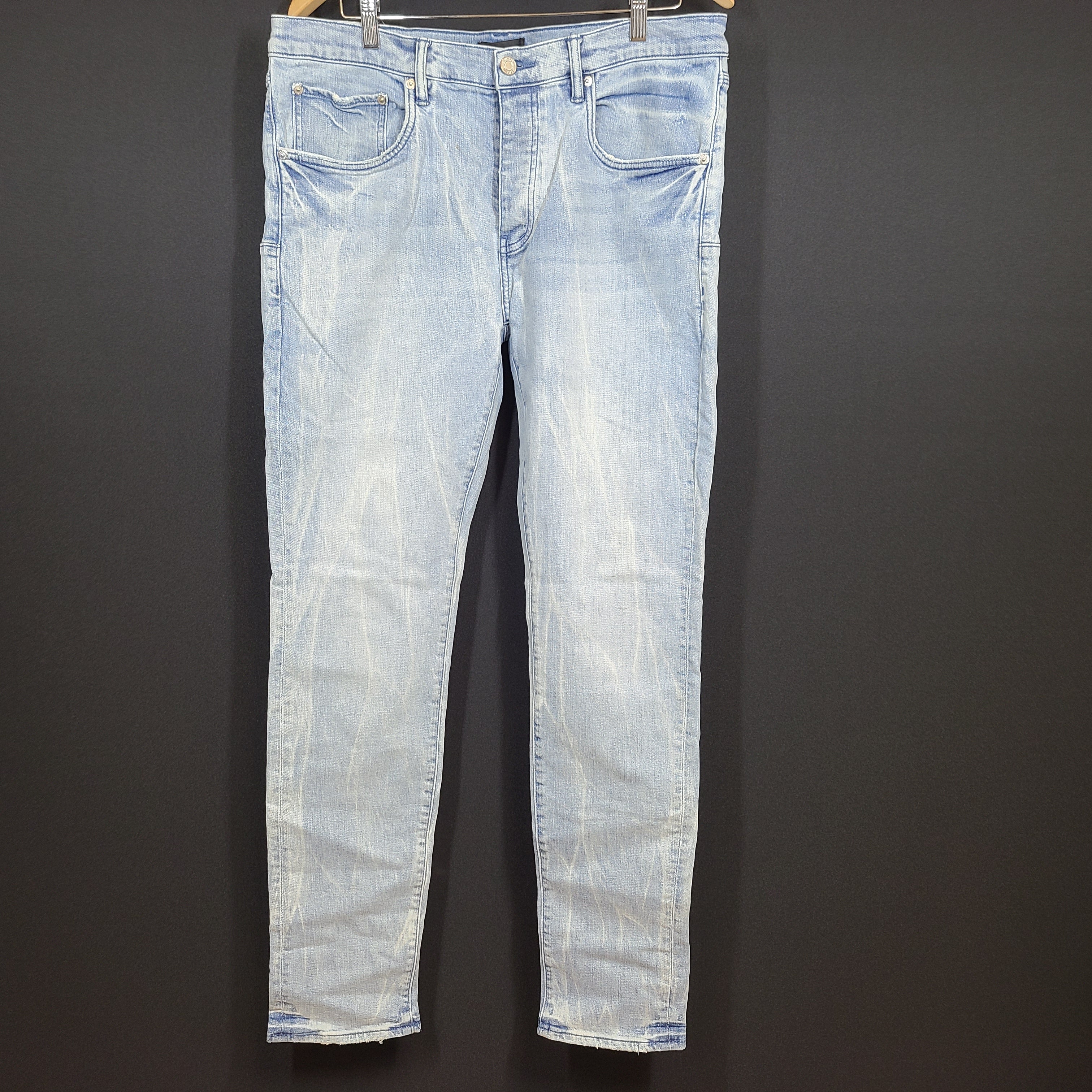 Slim-fit light blue jeans by Purple Brand with a leather patch and stretch fabric for comfortable movement.