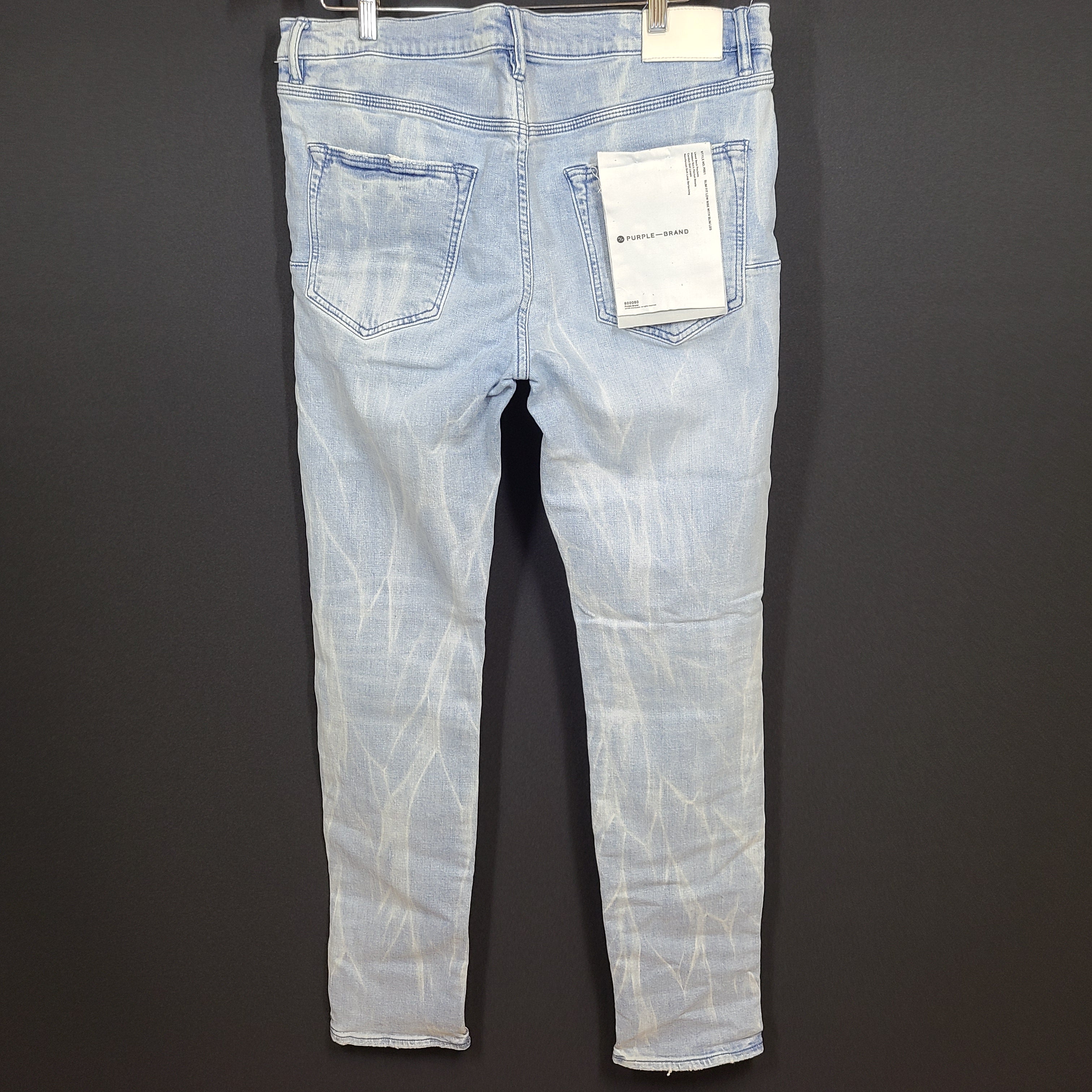 Slim-fit light blue jeans by Purple Brand with a leather patch and stretch fabric for comfortable movement.