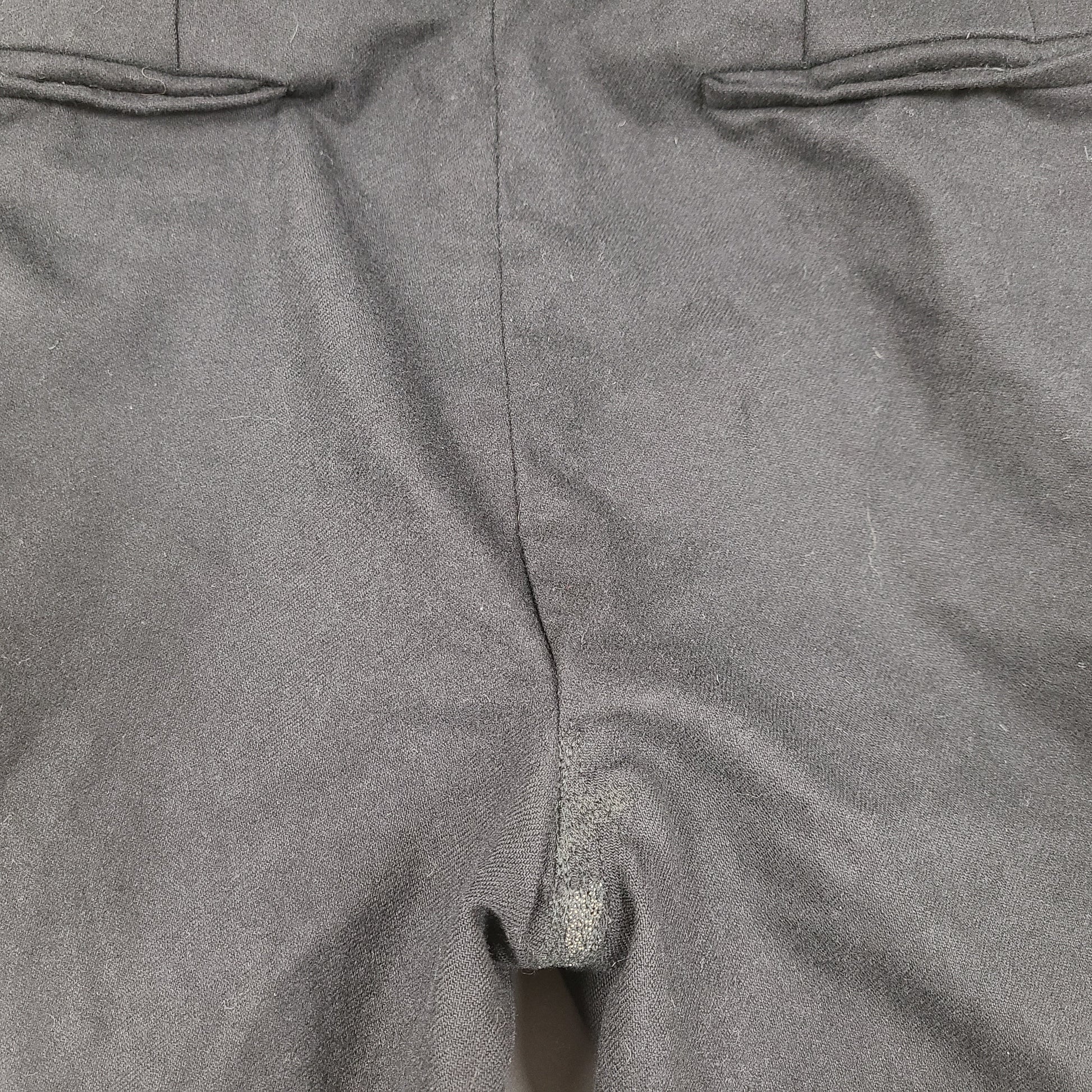 Black Givenchy wool trousers, size 52, with tailored straight-leg styling.