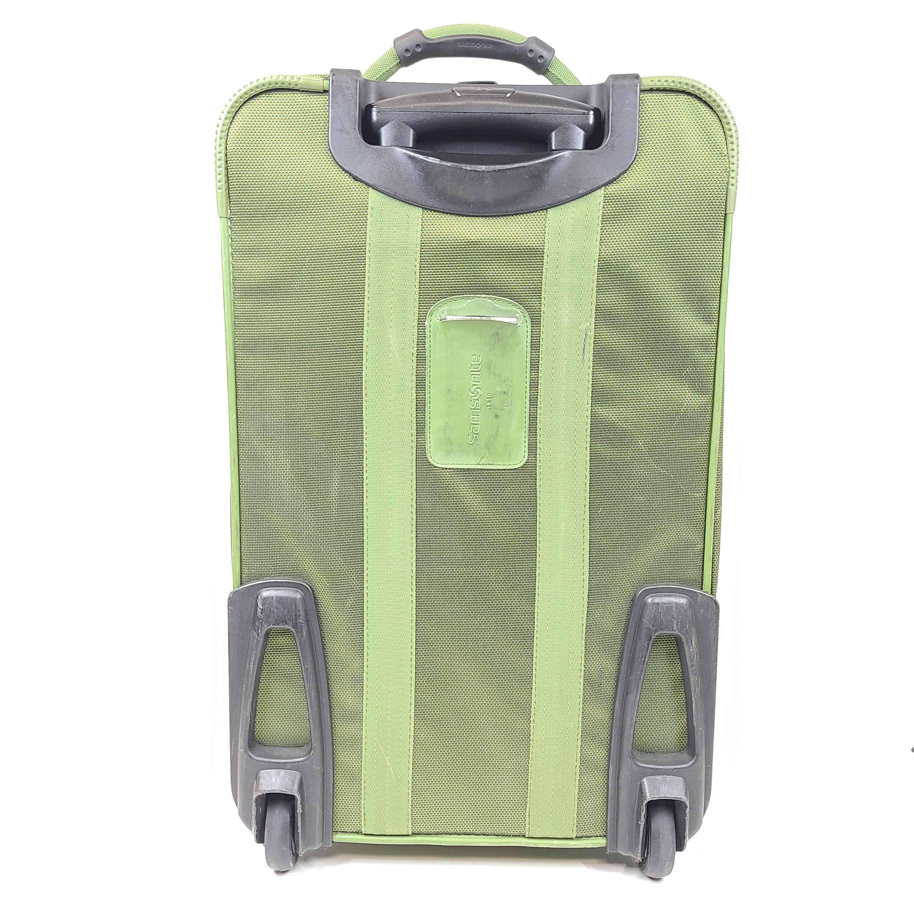 Green Samsonite suitcase model 4500025904 with scuff marks on wheels and handles.