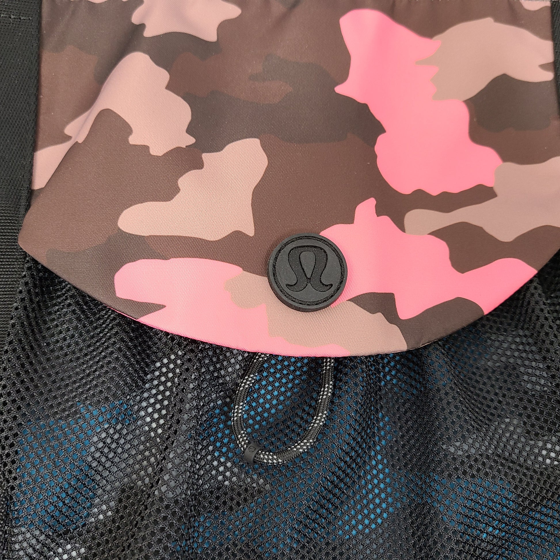 Multicolor Lululemon camouflage tote with pink, brown, green and blue panels and an internal label reading "items of importance".