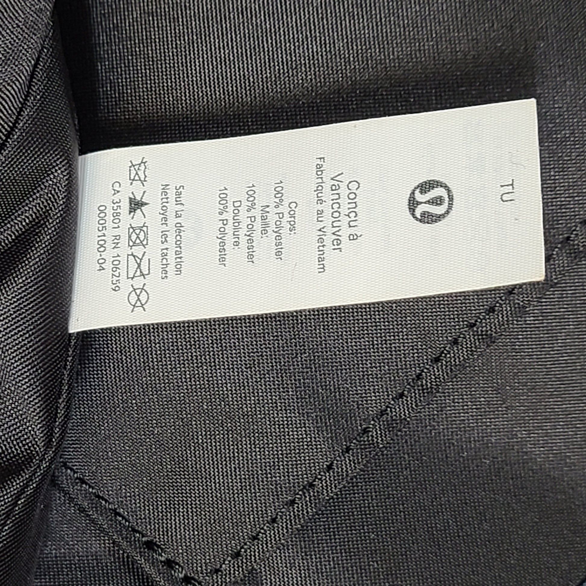 Multicolor Lululemon camouflage tote with pink, brown, green and blue panels and an internal label reading "items of importance".