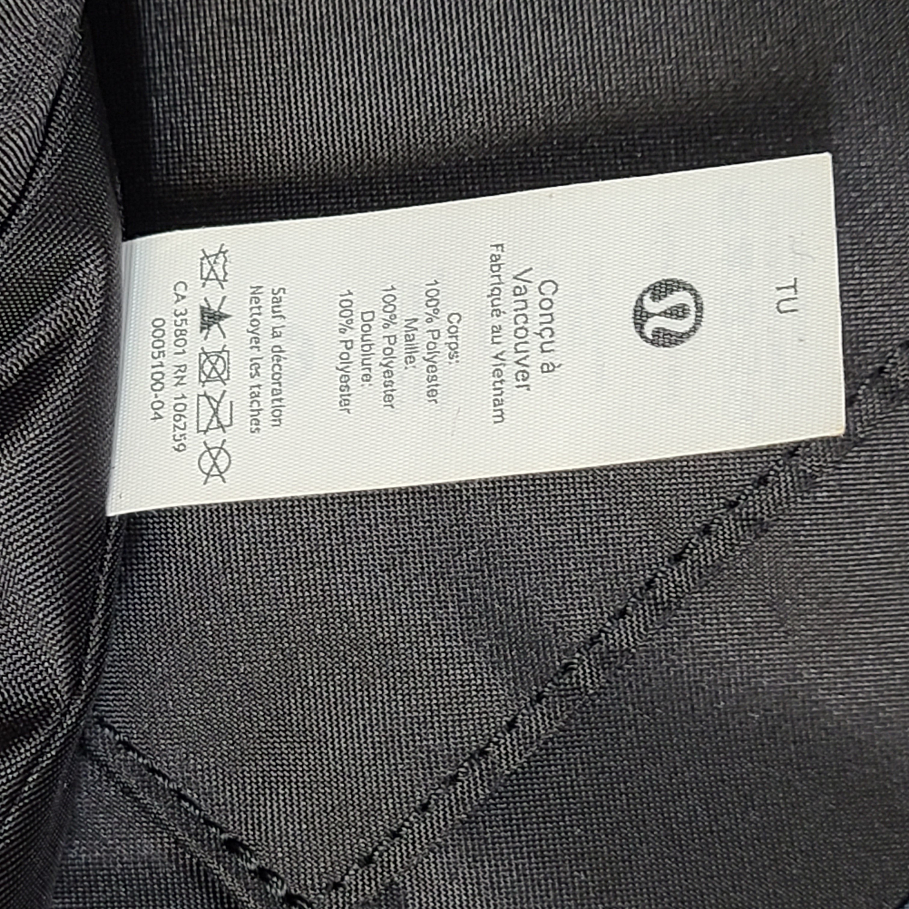 Multicolor Lululemon camouflage tote with pink, brown, green and blue panels and an internal label reading "items of importance".