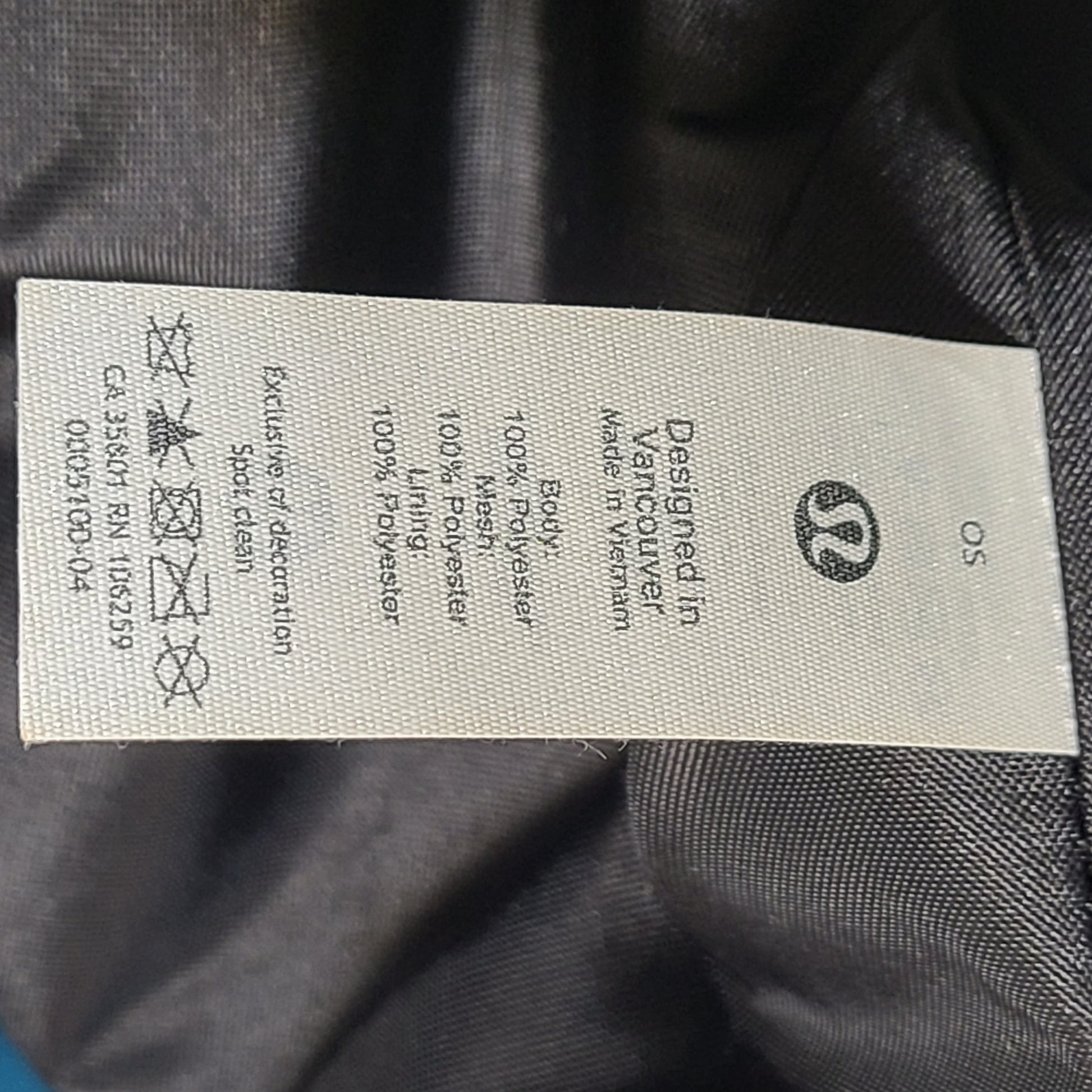 Multicolor Lululemon camouflage tote with pink, brown, green and blue panels and an internal label reading "items of importance".