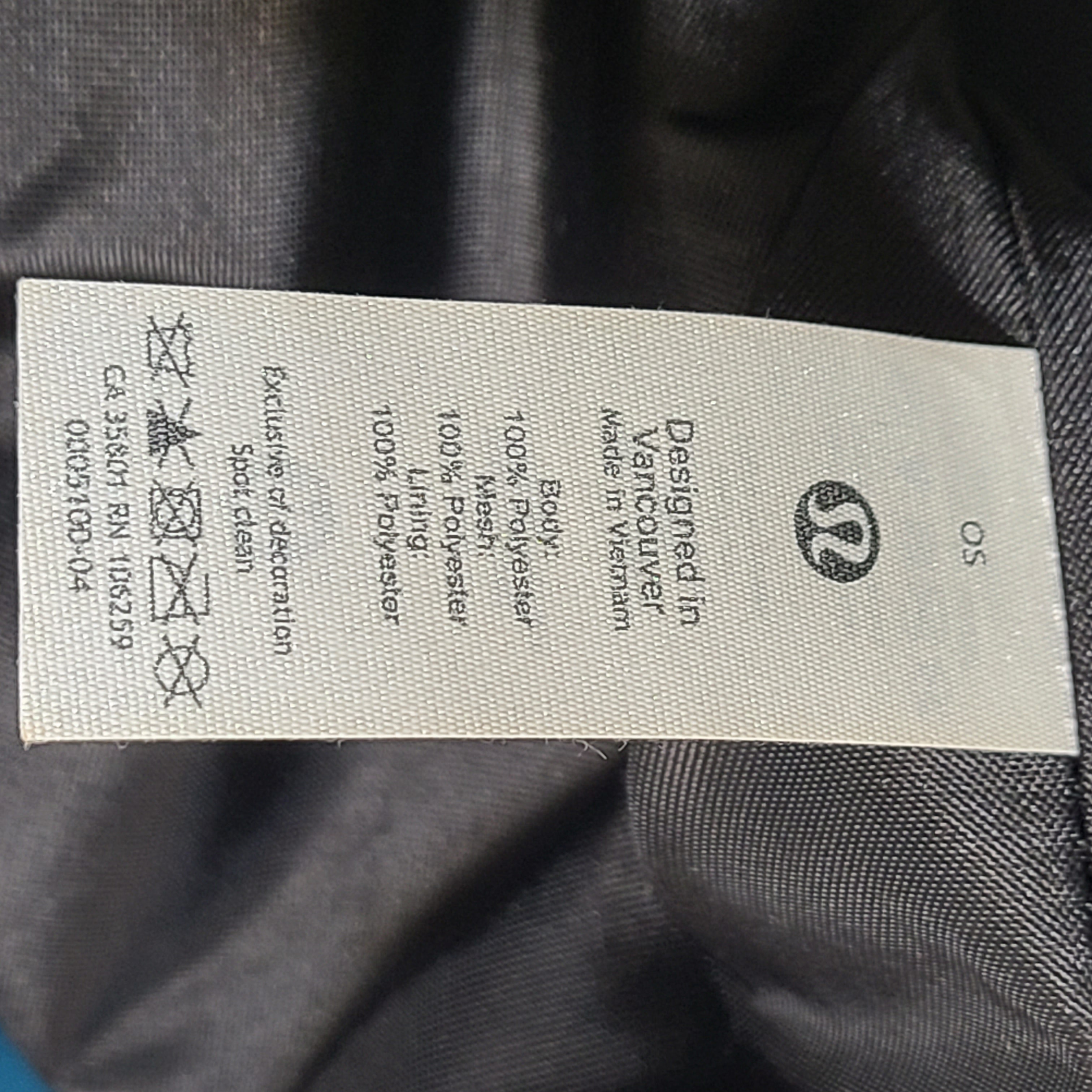 Multicolor Lululemon camouflage tote with pink, brown, green and blue panels and an internal label reading "items of importance".