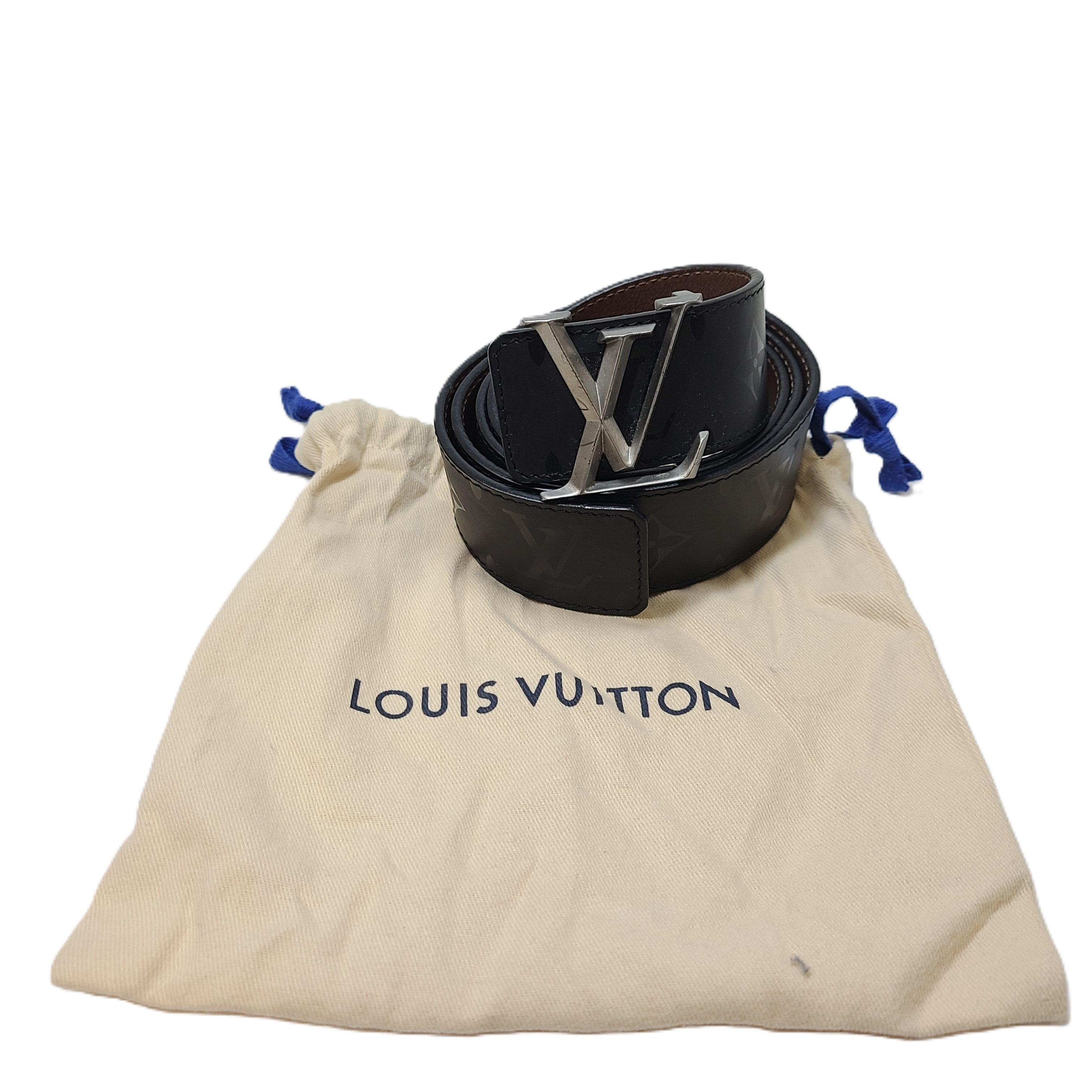 A black Louis Vuitton leather belt with monogram pattern, polished buckle, and Louis Vuitton Paris stamp.
